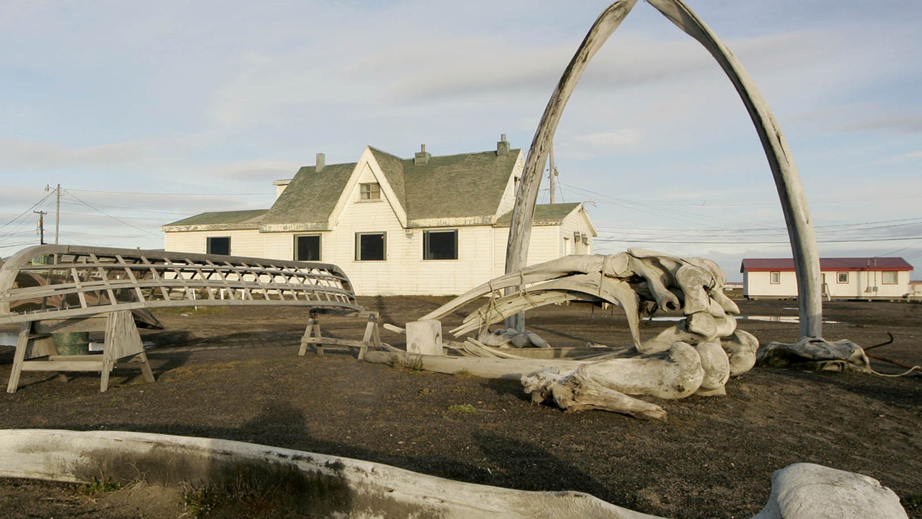 ILE - In this Aug. 12, 2005, file photo. a skin boat display sits next to whale bones and an arch made of a whale jaw on the beach at Brower's Cafe in Barrow, Alaska.