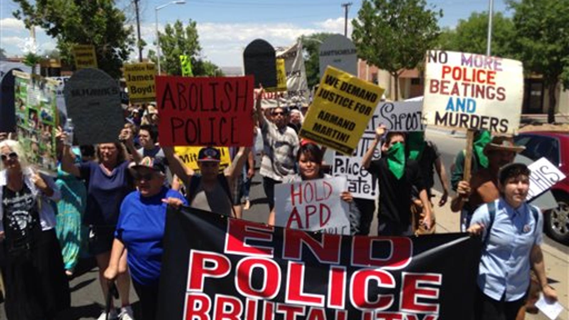 In this photo courtesy of David Correia, protesters march in a rally on Saturday, June 21, 2014 in Albuquerque, N.M. Critics of the Albuquerque Police Department say the march is aimed at pushing for drastic changes within Albuquerque police following a harsh U.S. Justice Department report over the agencys use of force. (AP Photo/Courtesy of David Correia)