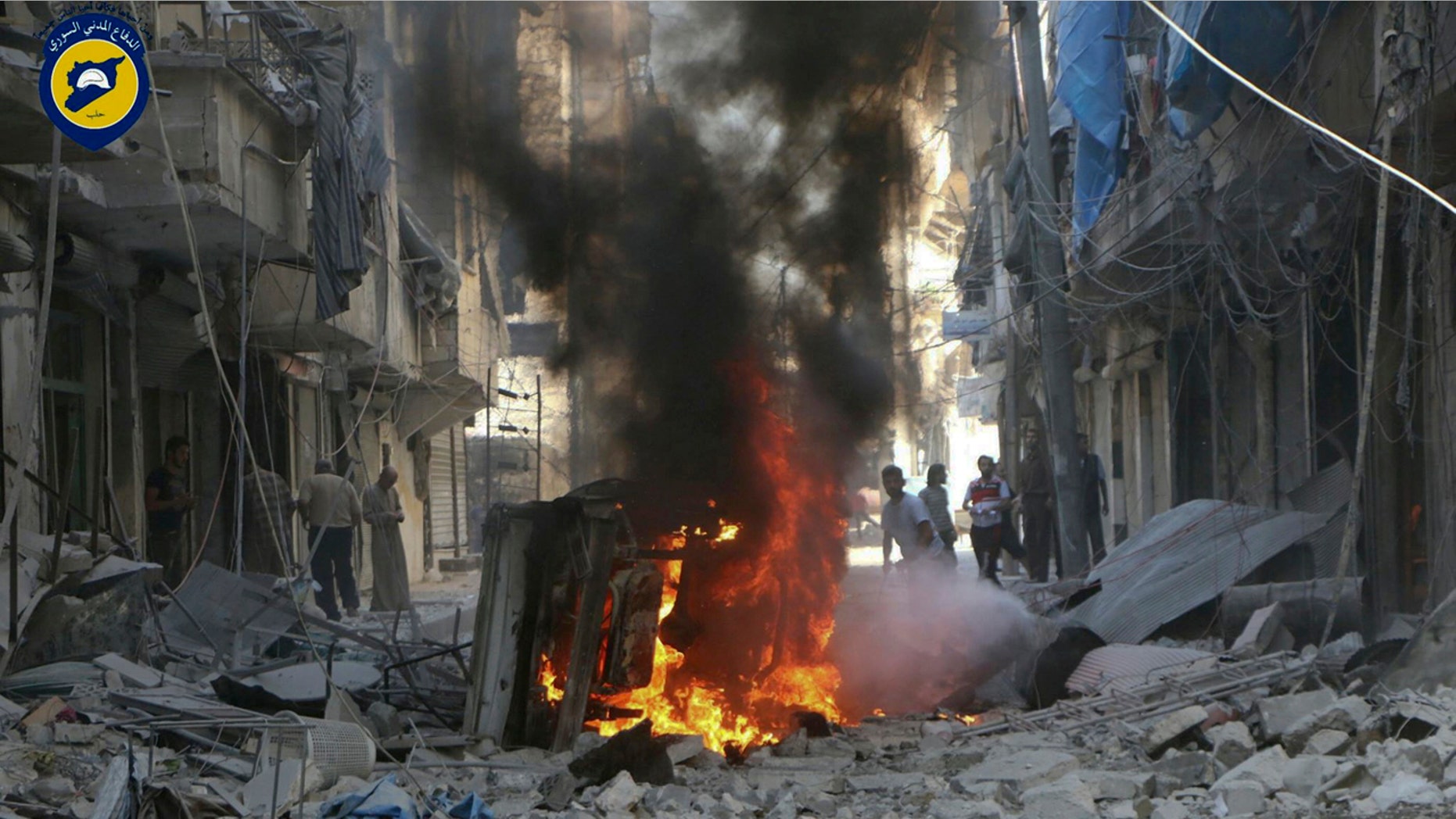 Syrians inspect damage after a government airstrike in Aleppo