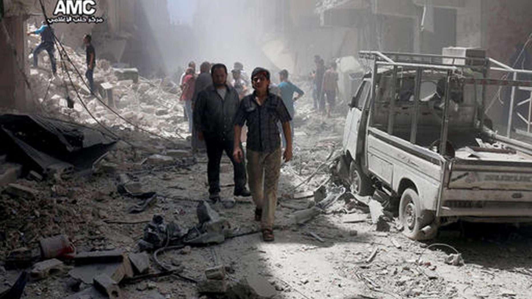 In this Tuesday, July. 26, 2016 file photo, provided by the Syrian anti-government activist group Aleppo Media Center (AMC), shows Syrian citizens inspect damaged buildings after airstrikes hit Aleppo, Syria. Fierce fighting and airstrikes continue in Syria's northern city of Aleppo as insurgents try to break a siege on opposition-held eastern districts in a counteroffensive to government advances. But Syria's war, now in its sixth year, is raging beyond Aleppo, claiming dozens of lives every day.