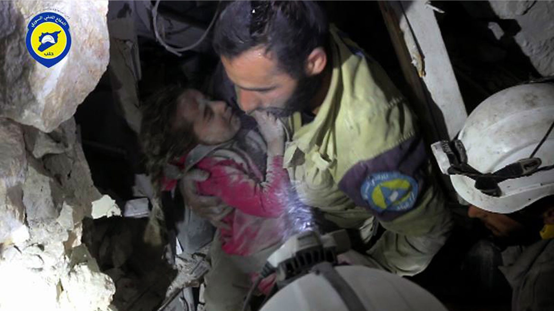 Sept. 28, 2016: This photo provided by the Syrian Civil Defense group known as the White Helmets shows a Civil Defense worker carrying Ghazal Akhtarini from under the rubble after airstrikes hit the al-Shaar neighborhood in Aleppo, Syria.