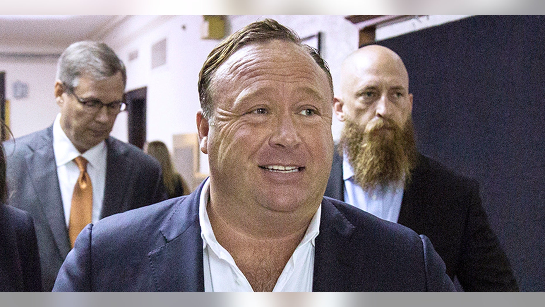 Twitter announced Thursday that it “permanently suspended” Alex Jones, center, and his show InfoWars from their platform, as well as Periscope.