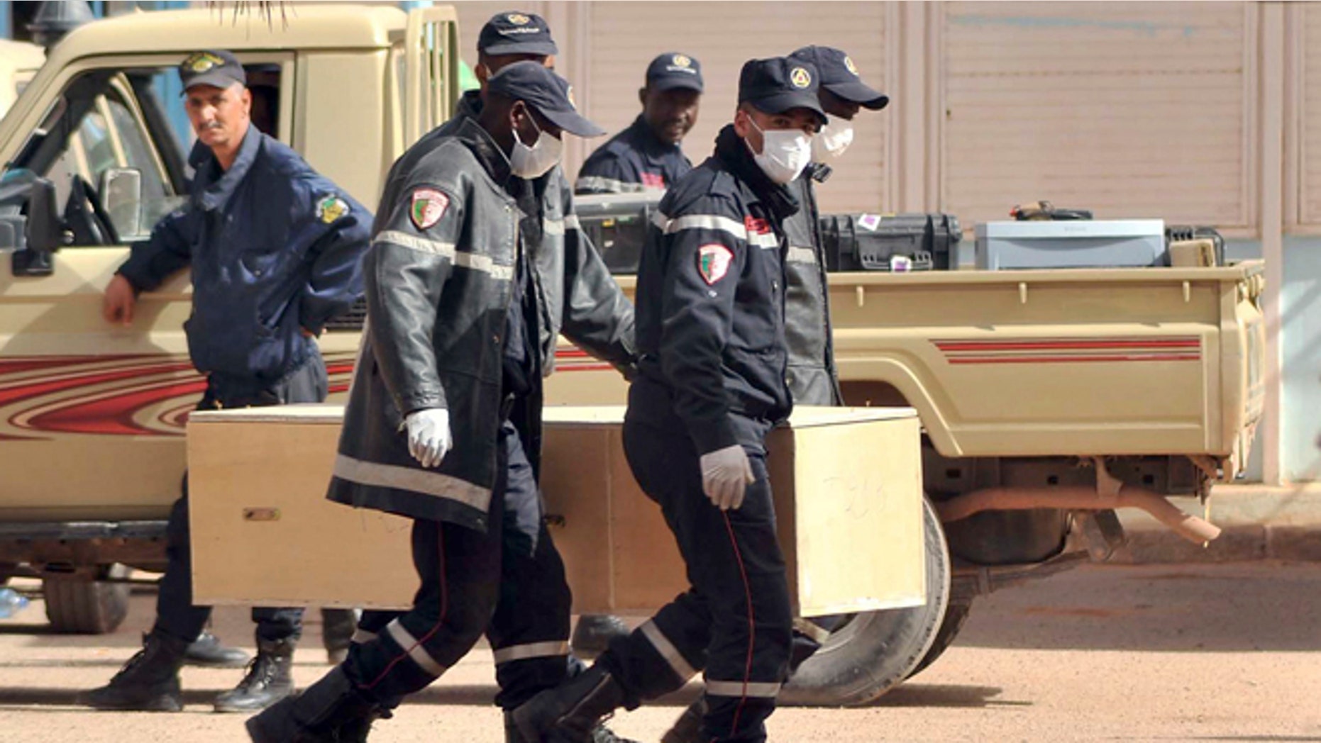 Jan. 21, 2013: Algerian firemen carry a coffin containing a person killed during the gas facility hostage situation at the morgue in Ain Amenas, Algeria.