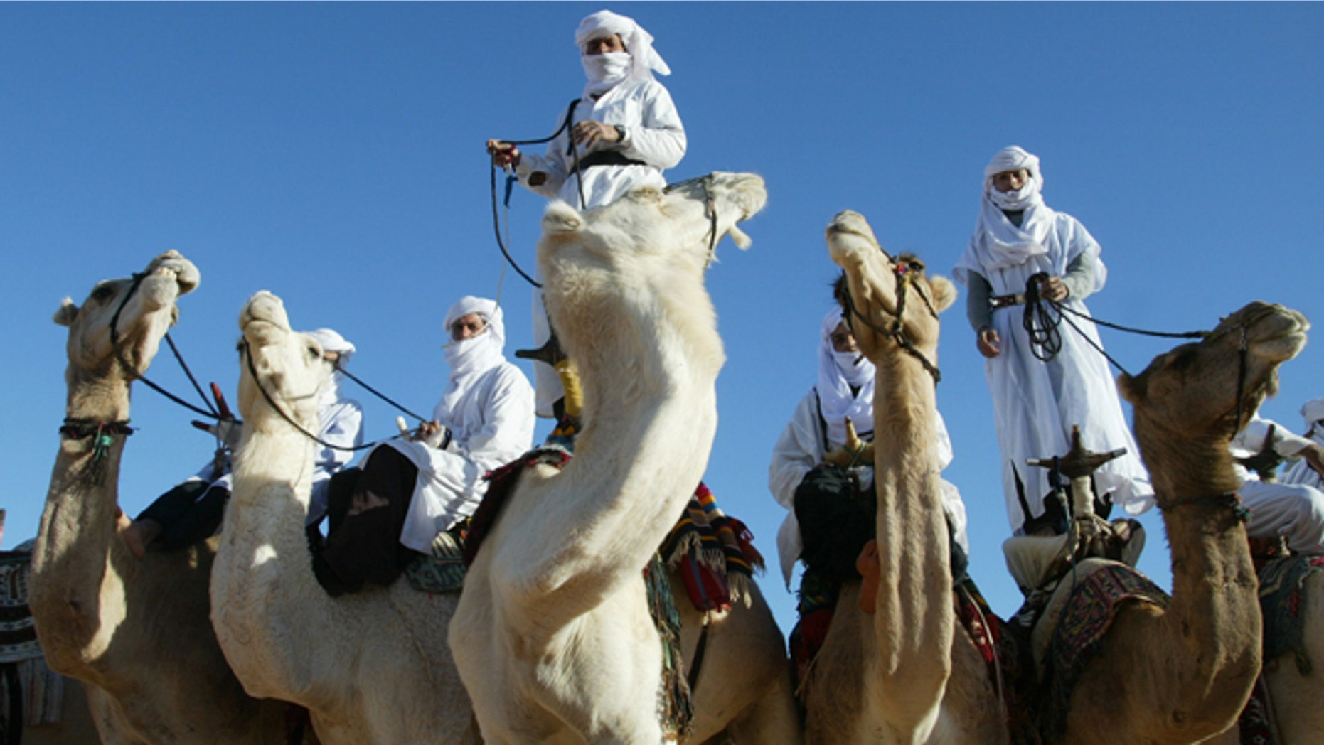 In this Dec. 12, 2002 file photo Tuaregs are shown on their camels outside Ghardaia, southern Algeria. The awe-inspiring dunes and wild mountains of Algerias Sahara have lured adventure travelers for decades, but their latest incarnation -- as a crossroad for the Al Qaeda militants who attacked a natural gas complex -- is likely to make them even more inaccessible.