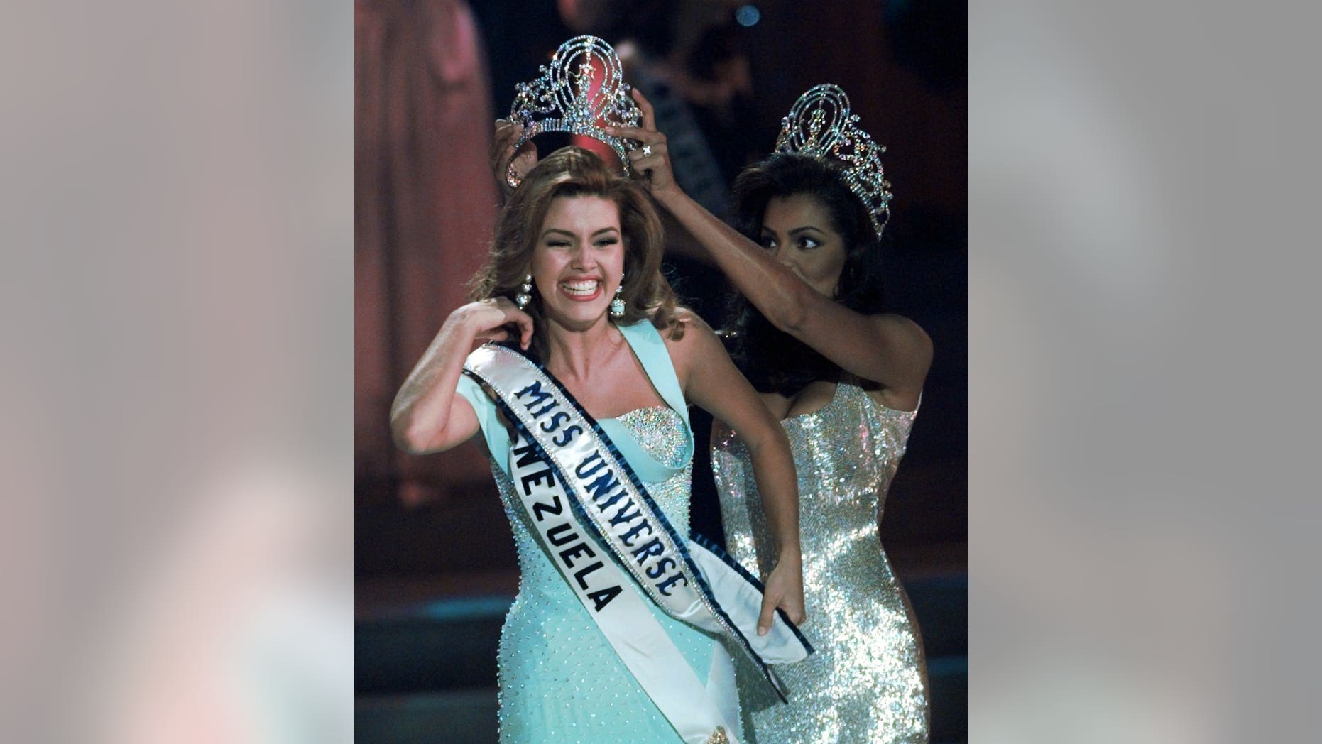 1996 Miss Universe Alicia Machado of Venezuela is crowned by the 1995 winner Chelsi Smith at the Miss Universe competition in Las Vegas.