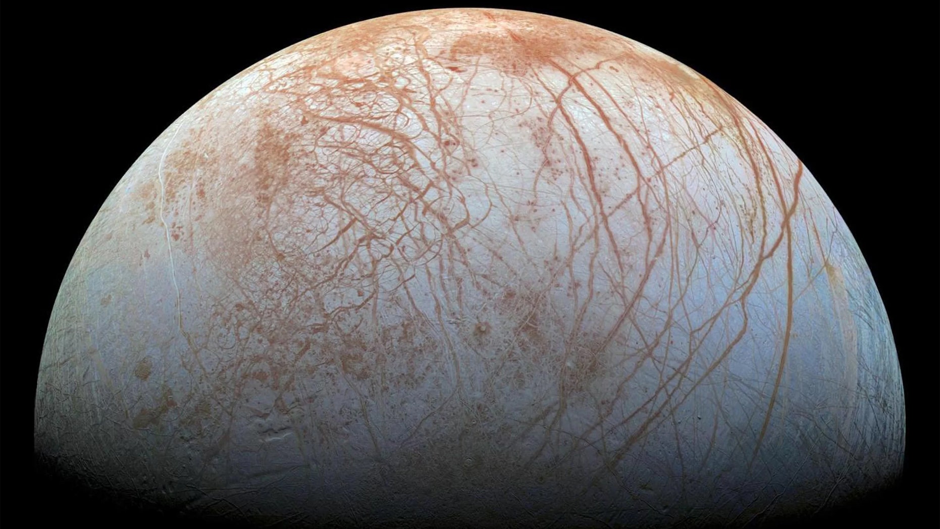 Europa's surface is a shell of ice covering a global ocean and displaying amazing features. Long, linear cracks and ridges crisscross the surface, broken by regions of disrupted terrain where the crust of surface ice has cracked and refrozen into new patterns. (Credit: NASA/JPL-Caltech)