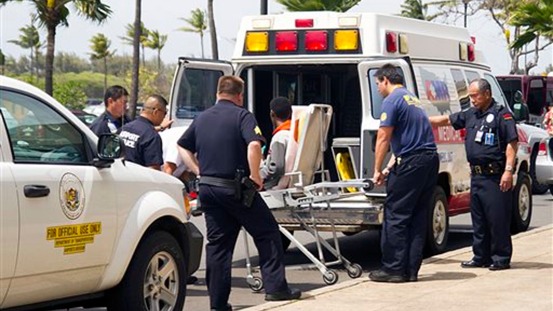 A 16-year-old boy, seen sitting on a stretcher center, who stowed away in the wheel well of a flight from San Jose, Calif., to Maui is loaded into an ambulance at Kahului Airport in Kahului, Maui, Hawaii Sunday afternoon, April 20, 2014. The boy survived the trip halfway across the Pacific Ocean unharmed despite frigid temperatures at 38,000 feet and a lack of oxygen, FBI and airline officials said. FBI spokesman Tom Simon in Honolulu told The Associated Press on Sunday night that the boy was questioned by the FBI after being discovered on the tarmac at the Maui airport with no identification. "Kid's lucky to be alive," Simon said. (AP Photo/The Maui News, Chris Sugidono)