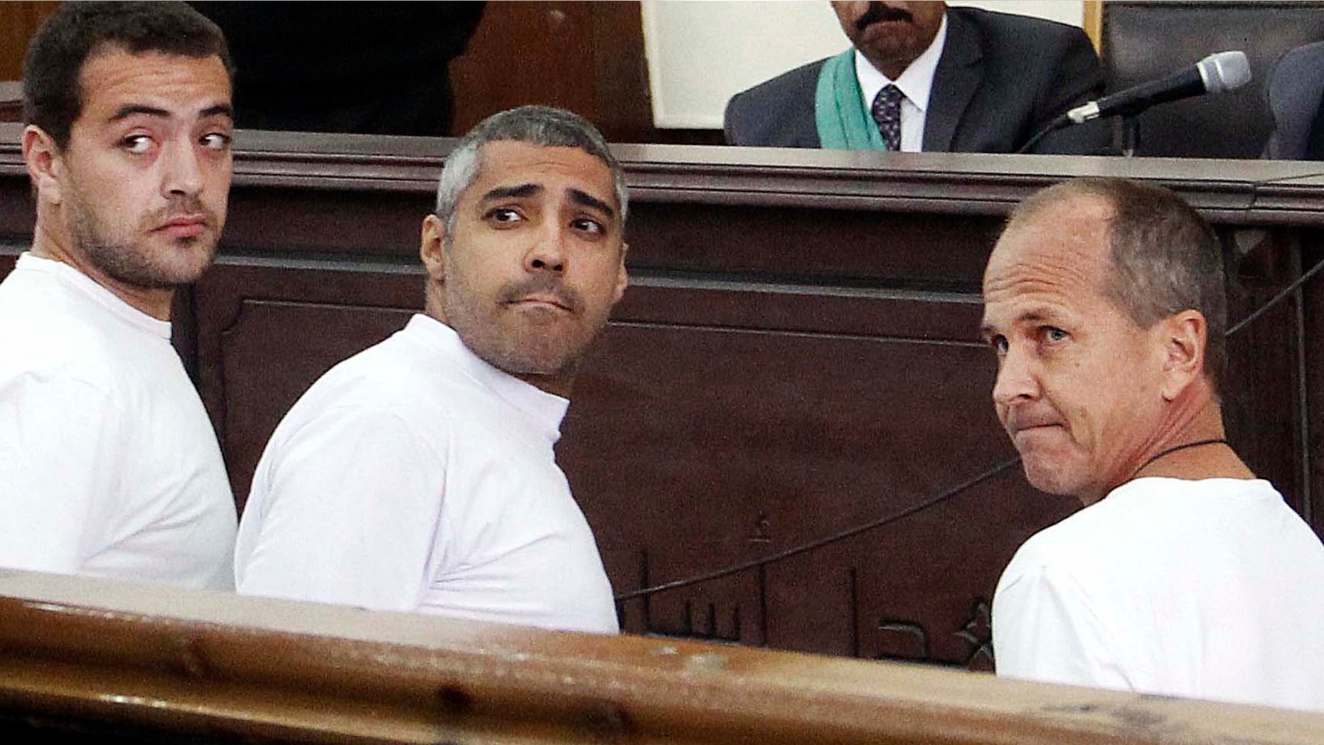 March 31, 2014: Al-Jazeera English producer Baher Mohamed, left, Canadian-Egyptian acting Cairo bureau chief Mohammed Fahmy, center, and correspondent Peter Greste, right, appear in court along with several other defendants during their trial on terror charges, in Cairo