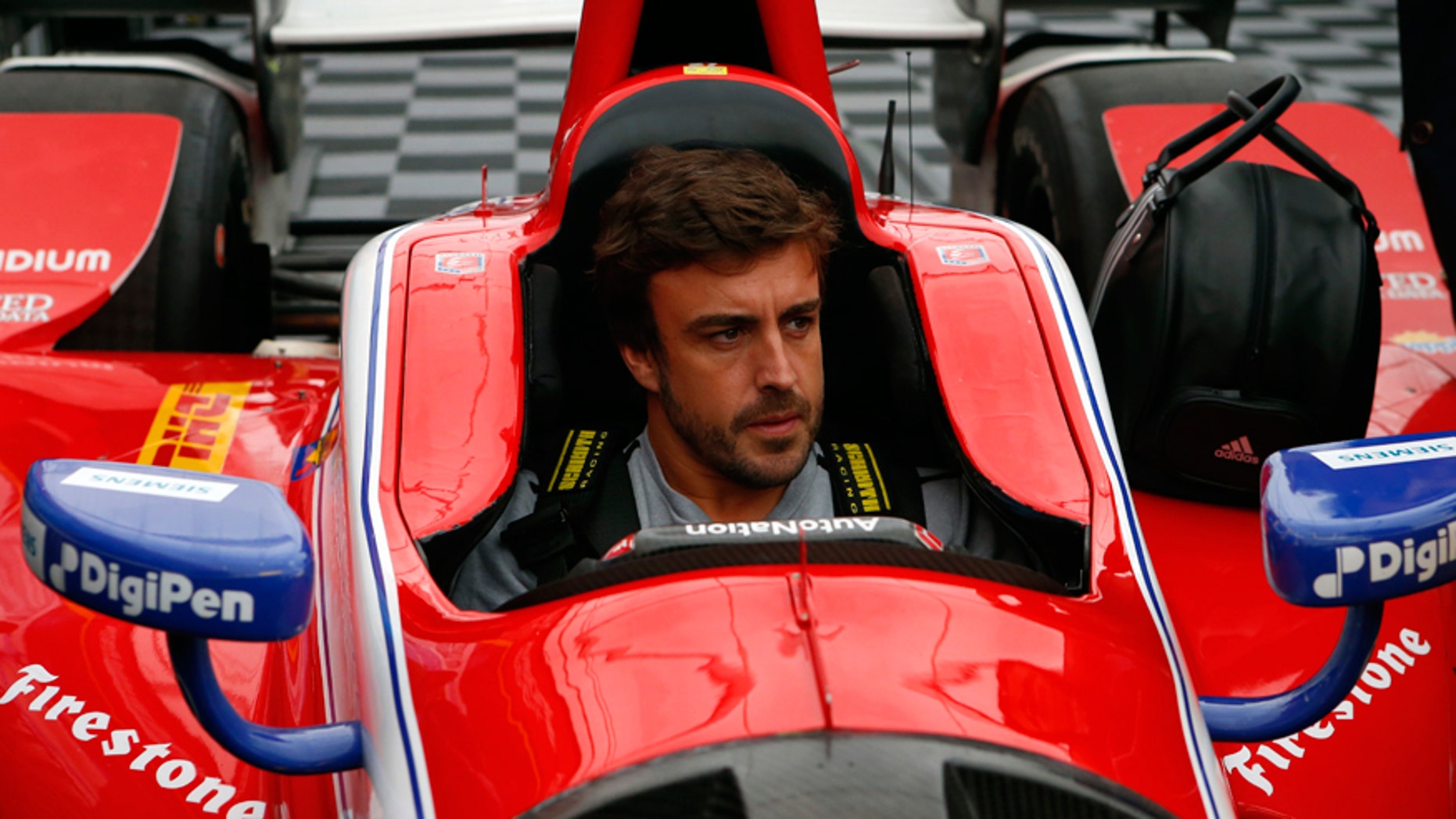Fernando Alonso being fitted for an IndyCar at Barber Motorsports Park in Alabama on April 23.