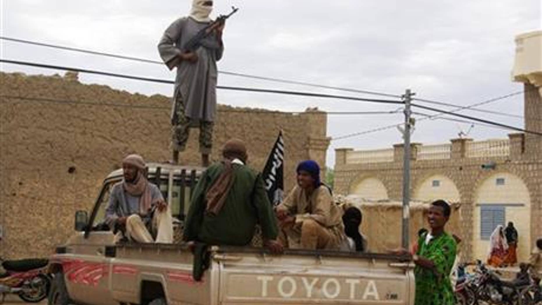 Aug. 31, 2012: Fighters from the Al-Qaeda-linked Islamist group Ansar Dine stand guard in Timbuktu, Mali.