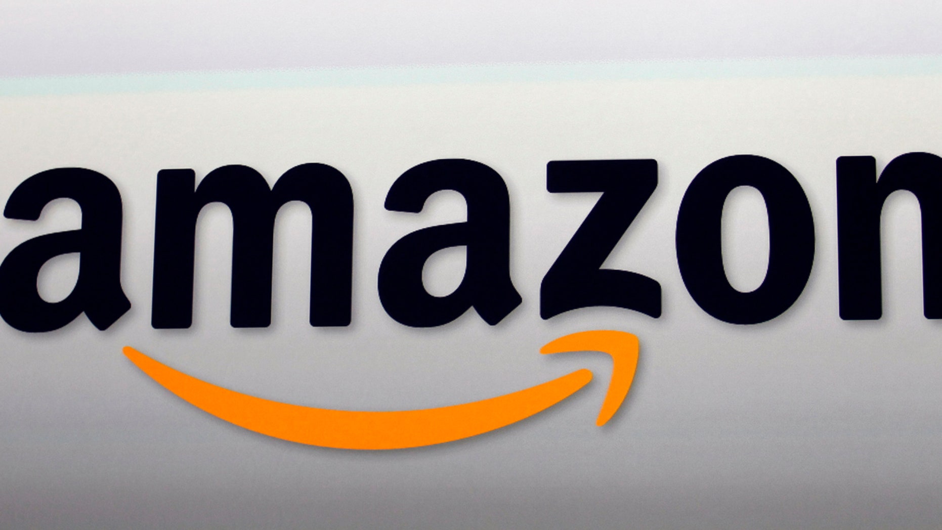 FILE - This Sept. 6, 2012, file photo, shows the Amazon logo in Santa Monica, Calif. Amazon will block Australians from buying from its international e-commerce websites and restrict them to a smaller local platform from July in response to new tax rules that consumer advocates fear will reduce the range of choice for customers in Australia, Amazon said in a statement on Friday June 1, 2018. (AP Photo/Reed Saxon, File)