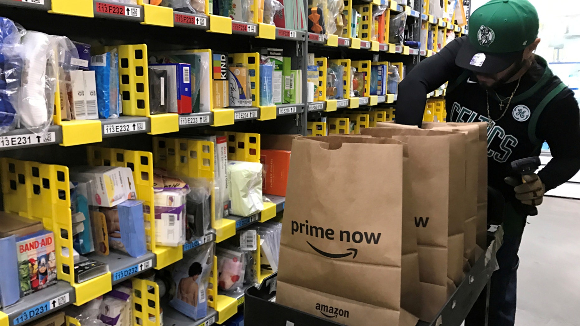 FILE PHOTO: An employee collects items ordered by Amazon.com customers through the company's two-hour delivery service Prime Now in a warehouse in San Francisco, California, U.S., December 20, 2017. REUTERS/Jeffrey Dastin