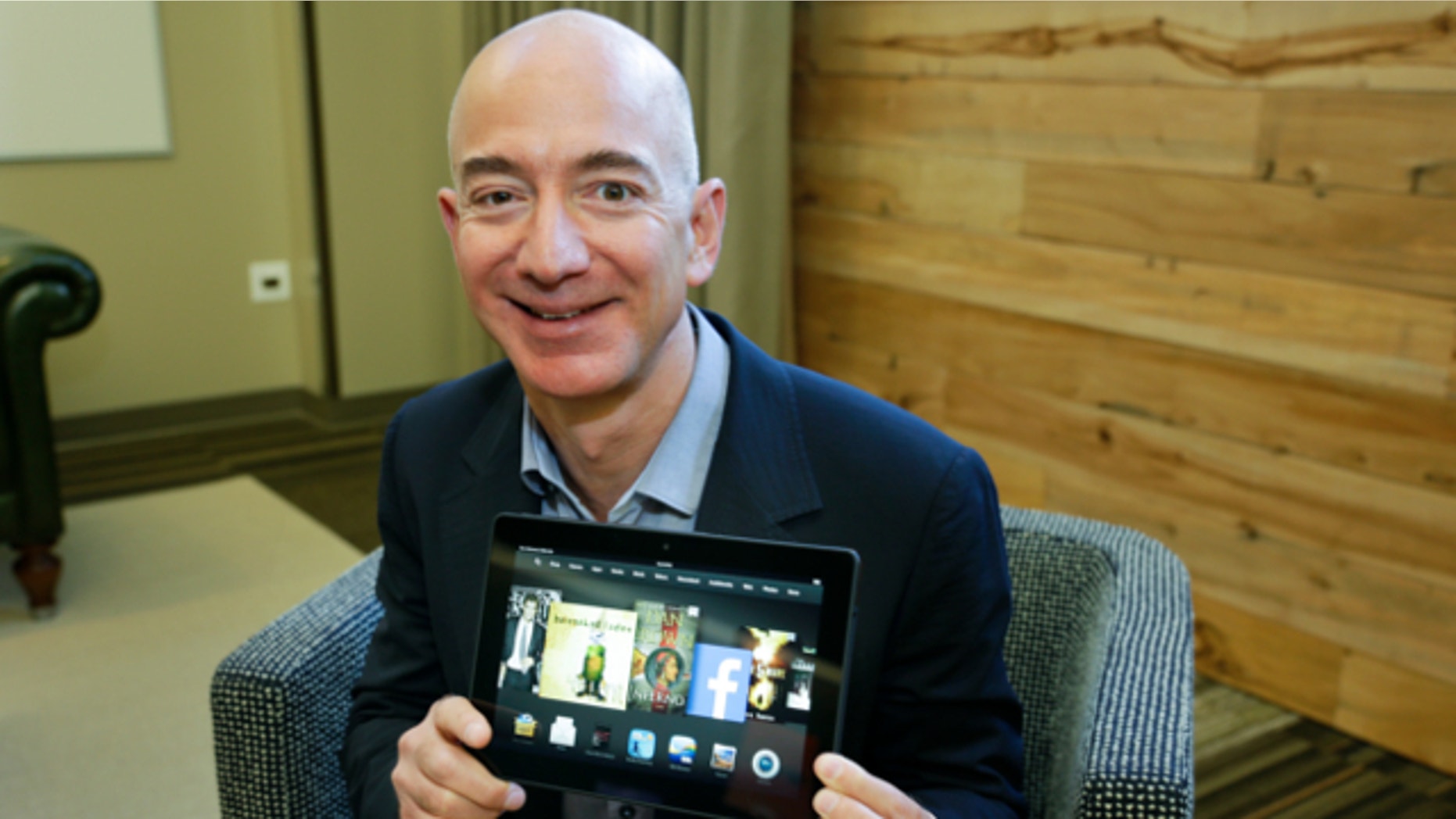 Sept. 24, 2013: Jeff Bezos, CEO of Amazon.com, poses for a photo with the 8.9-inch version of the new Amazon Kindle HDX tablet computer in Seattle.