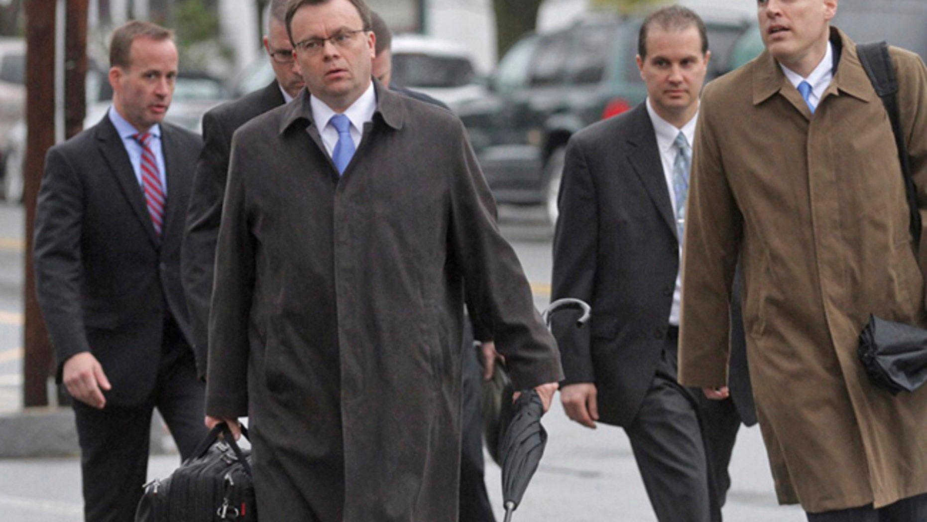 Pike County District Attorney Ray Tonkin, front center, arrives for the first day of the trial of Eric Frein, an anti-government survivalist accused of killing a Pennsylvania police trooper and injuring a second in a 2014 ambush at their barracks, on Tuesday, April 4, 2017, at the Pike County Courthouse in Milford, Pa. Frein could face a death sentence if convicted in the sneak attack in northeastern Pennsylvania that killed Cpl. Bryon Dickson II, critically wounded Trooper Alex Douglass and led to a 48-day manhunt in the Pocono Mountains before U.S. marshals captured Frein. (Mike Mullen/The Times-Tribune via AP)