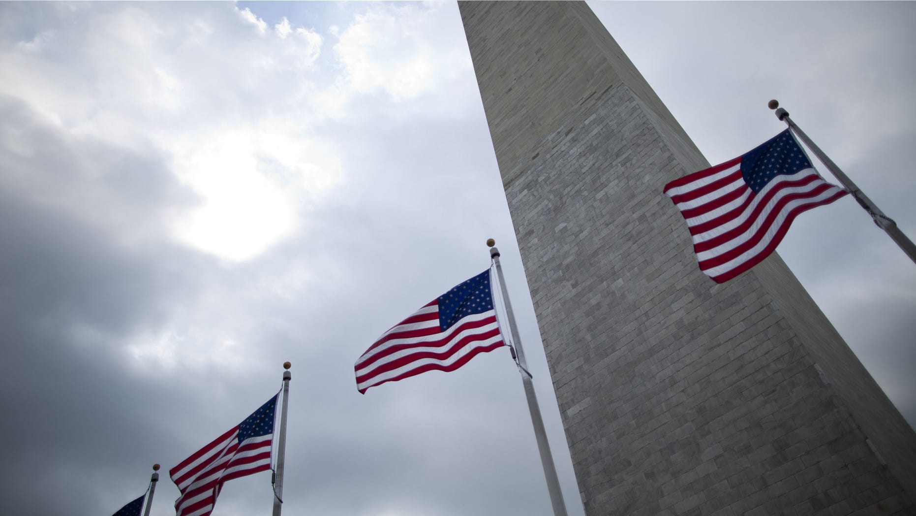 WASHINGTON, DC - MAY 2: Flags fly at the base of the Washington Monument May 2, 2011 in Washington, DC. The DC area and other places around the nation have stepped up security after it was announced that Osama bin Laden, mastermind of the September 11th terror attacks, was killed in a firefight with United States forces in Pakistan. (Photo by Brendan Smialowski/Getty Images)