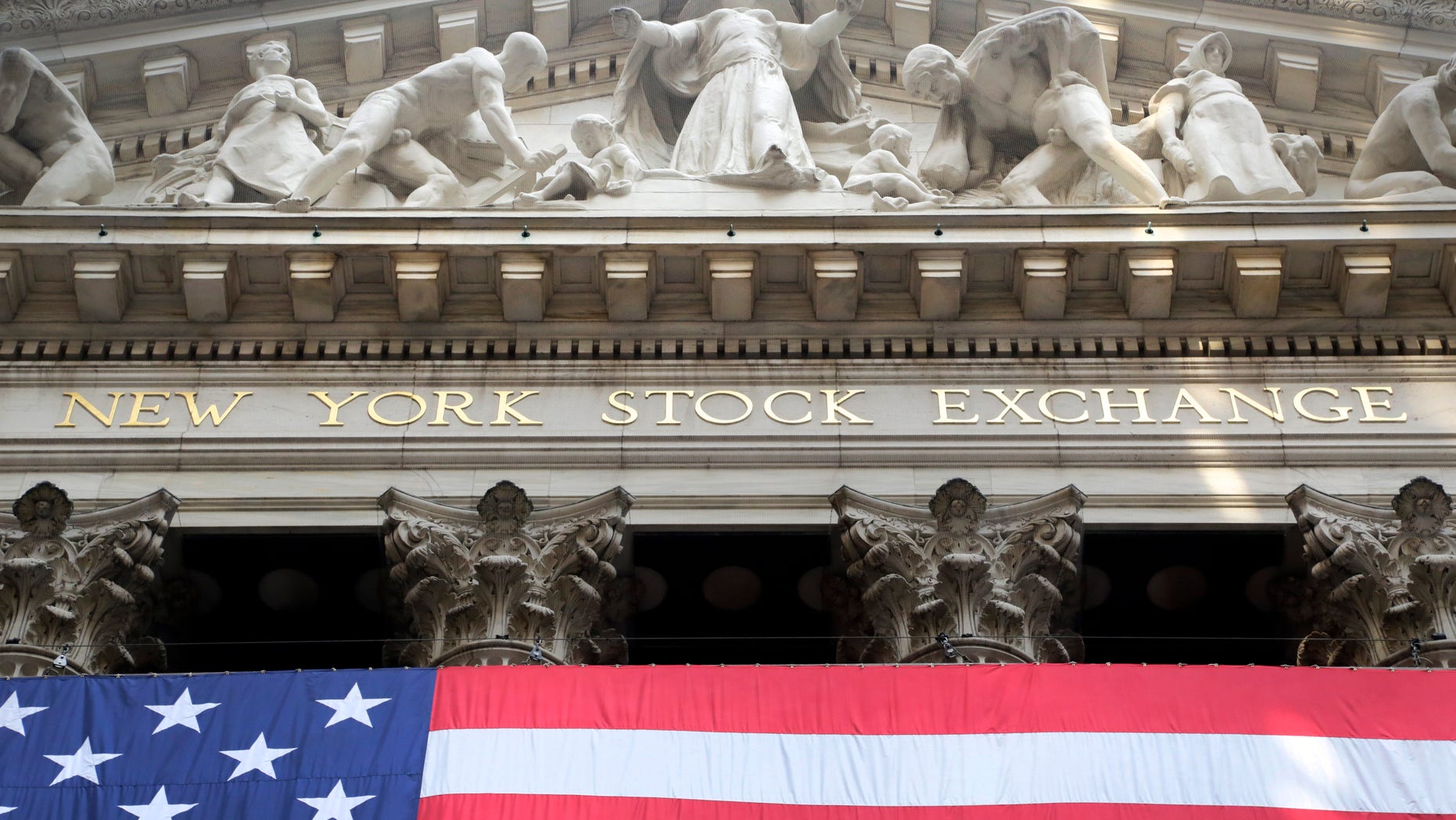 FILE -- July 6, 2015: An American flag is draped on the exterior of the New York Stock Exchange. (AP Photo/Mark Lennihan)