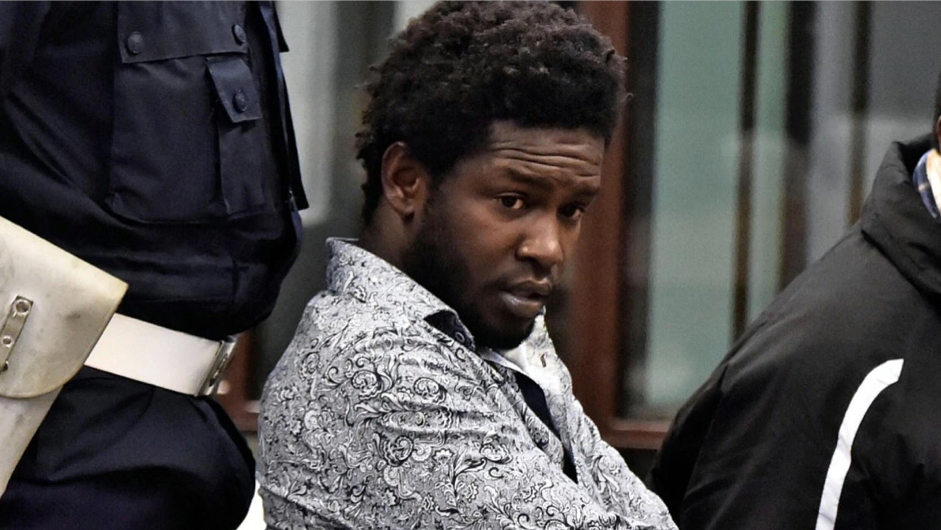 Dec. 22, 2016: Cheik Tidiane Diaw, left, sits in a courtroom in Florence, Italy. Diaw was convicted of murdering American Ashley Olsen, 35, in her flat on Jan. 9, 2016 after they met at a nightclub, and sentenced to 30 years in prison.