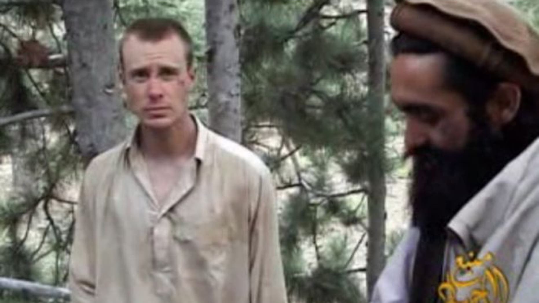 Dec. 8, 2010: This file image provided by IntelCenter shows a framegrab from a video released by the Taliban containing footage of a man believed to be Sgt. Bowe Bergdahl, left.