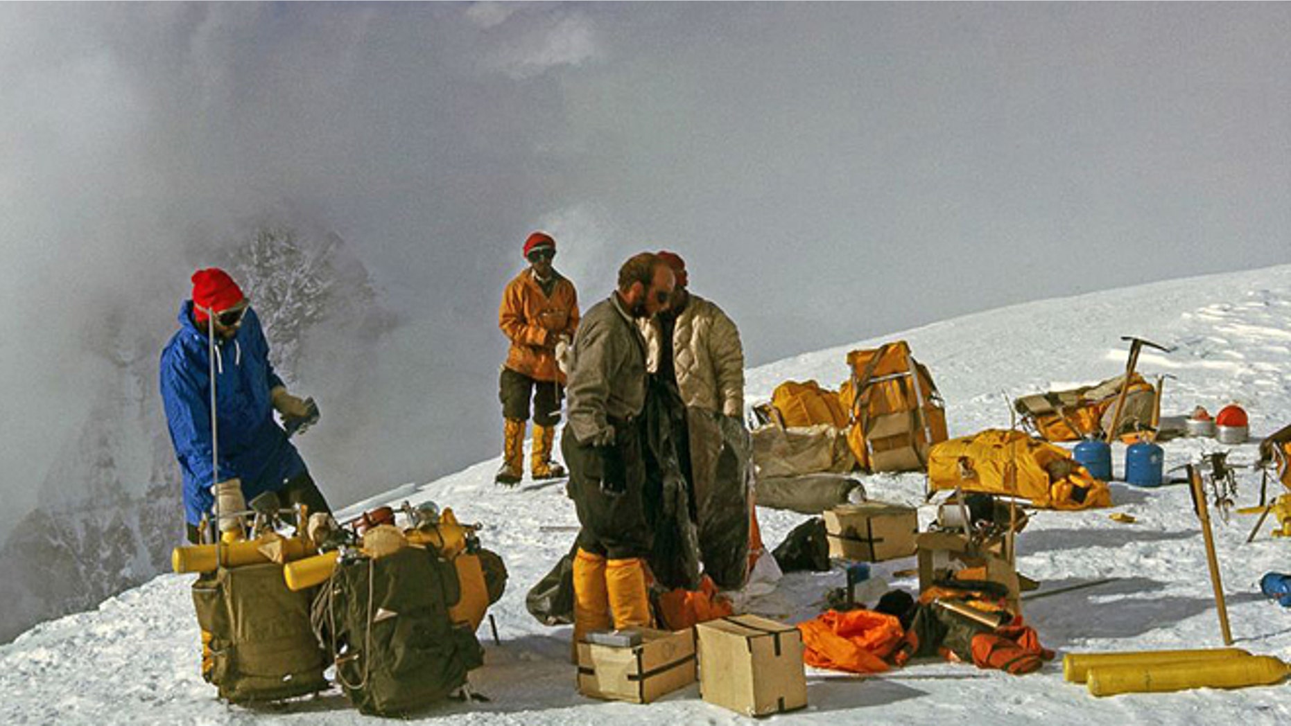 In this 1963 photo released by Henry S. Hall, Jr. American Alpine Club Library, Barry Corbet Personal Papers and Films, members of the 1963 American Mount Everest Expedition team and sherpas are shown with their climbing gear on Mt. Everest.