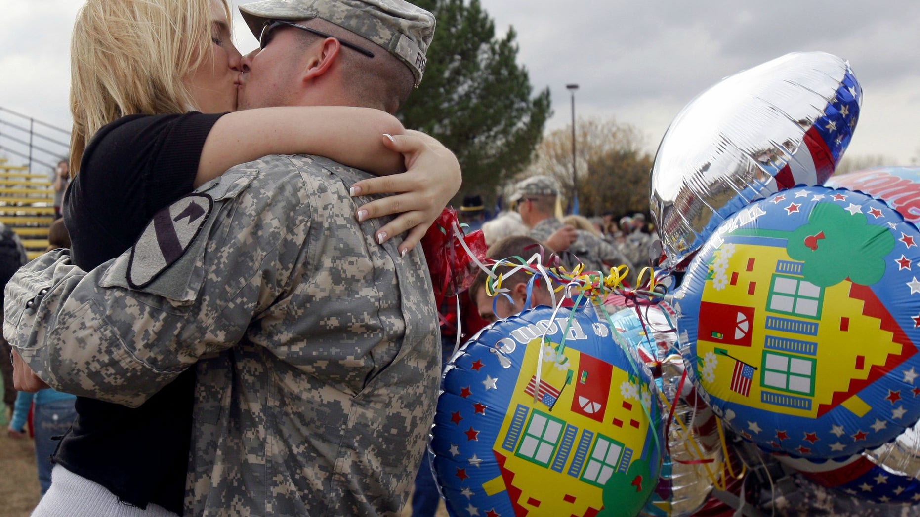 Spc. Andrew Fisk, of the First Calvary Division, kisses his wife Meisha, at a homecoming ceremony in Fort Hood, Texas, Dec. 19, 2007.