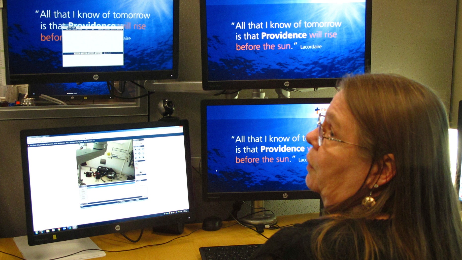 In this photo taken Sept. 13, 2016, intensive care unit nurse Deborah Springer in Anchorage, Alaska, demonstrates the focusing ability of a telemedicine camera that is part of a new telemedicine partnership between the Iliuliuk Family and Health Services on Unalaska Island and Providence Alaska Medical Center. Beginning Thursday, Sept. 22, the Anchorage hospital will virtually beam critical care doctors 800 miles away to the emergency room of the clinic to assist staffers there during medical emergencies, thanks to a satellite link instead of the usual fiber optics.