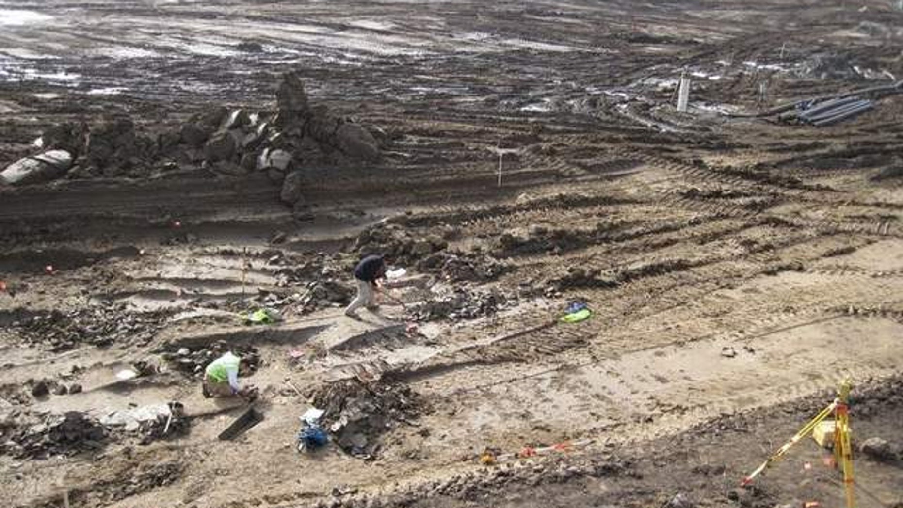Workers dig at the scene where the remains were found in January. The exact location, where a sewer project is under way, is not being disclosed because of fears of looting.