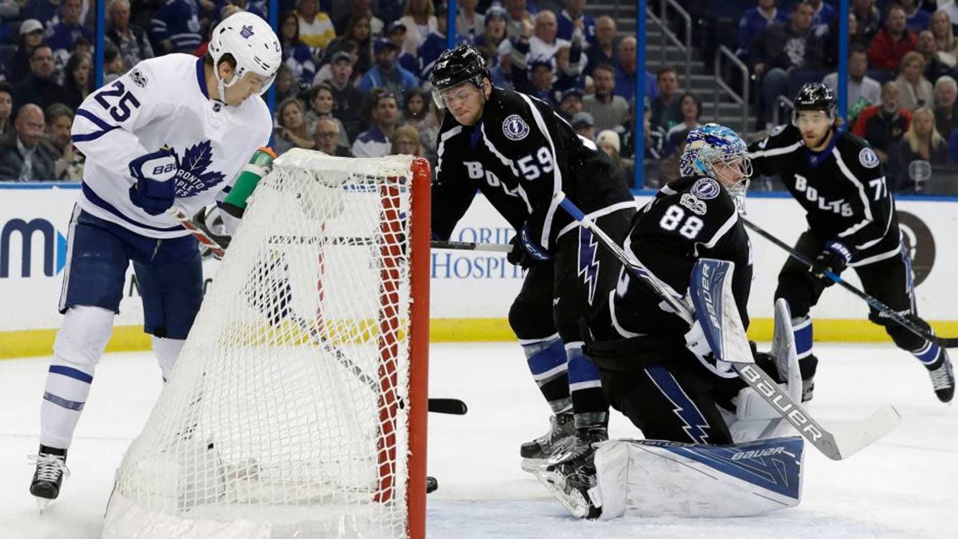 Toronto Maple Leafs left wing James van Riemsdyk (25) watches a goal by defenseman Roman Polak get behind Tampa Bay Lightning goalie Andrei Vasilevskiy (88) for a goal during the first period of an NHL hockey game Thursday, March 16, 2017, in Tampa, Fla. Defending for the Lightning are defenseman Jake Dotchin (59) and defenseman Victor Hedman (77) (AP Photo/Chris O'Meara)