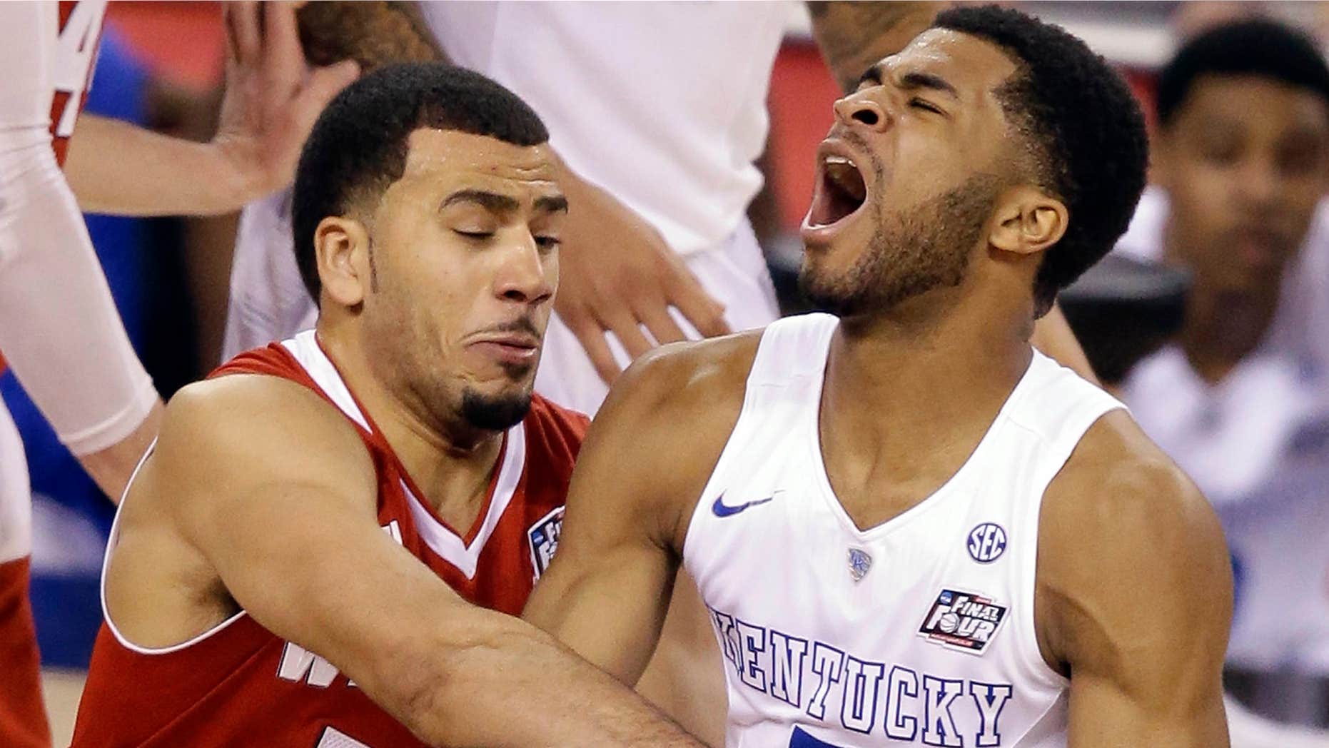 April 5, 2015: Wisconsin's Traevon Jackson (12) fouls Kentucky's Andrew Harrison (5) during the second half of the NCAA Final Four tournament college basketball semifinal game.