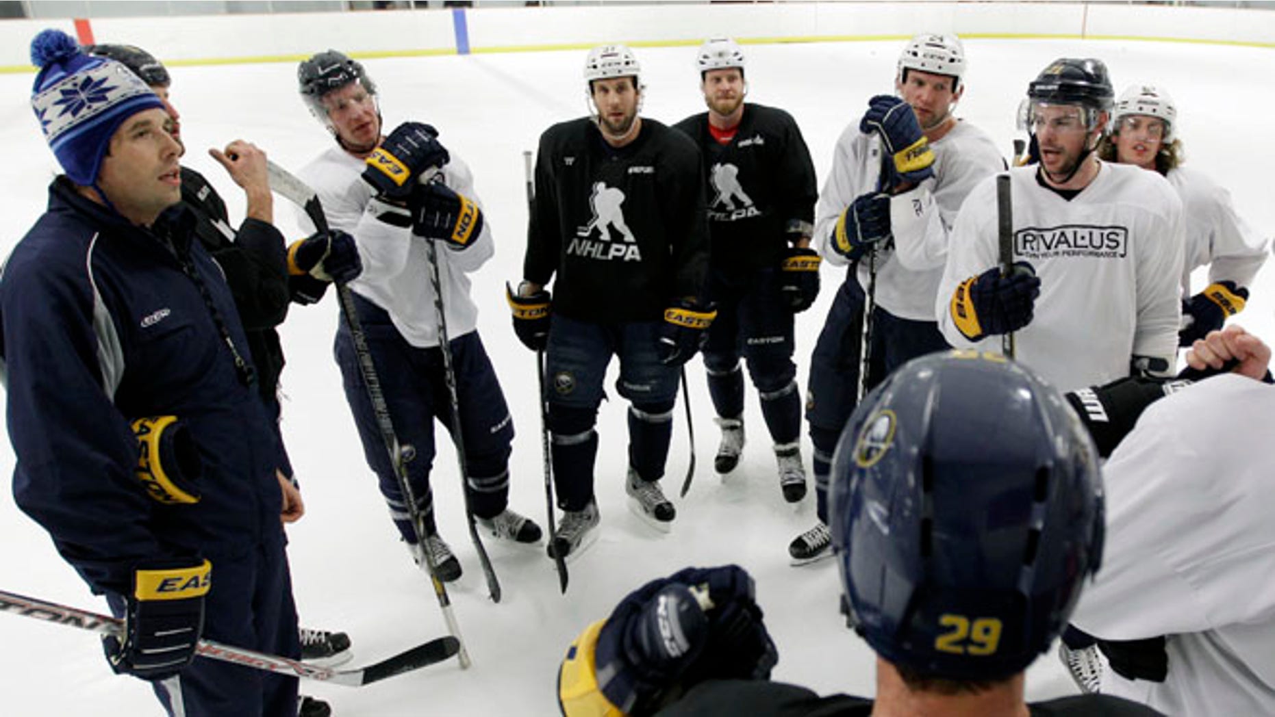 Former Buffalo Sabres player Andrew Peters, left, attends a Sabres workout in 2013.