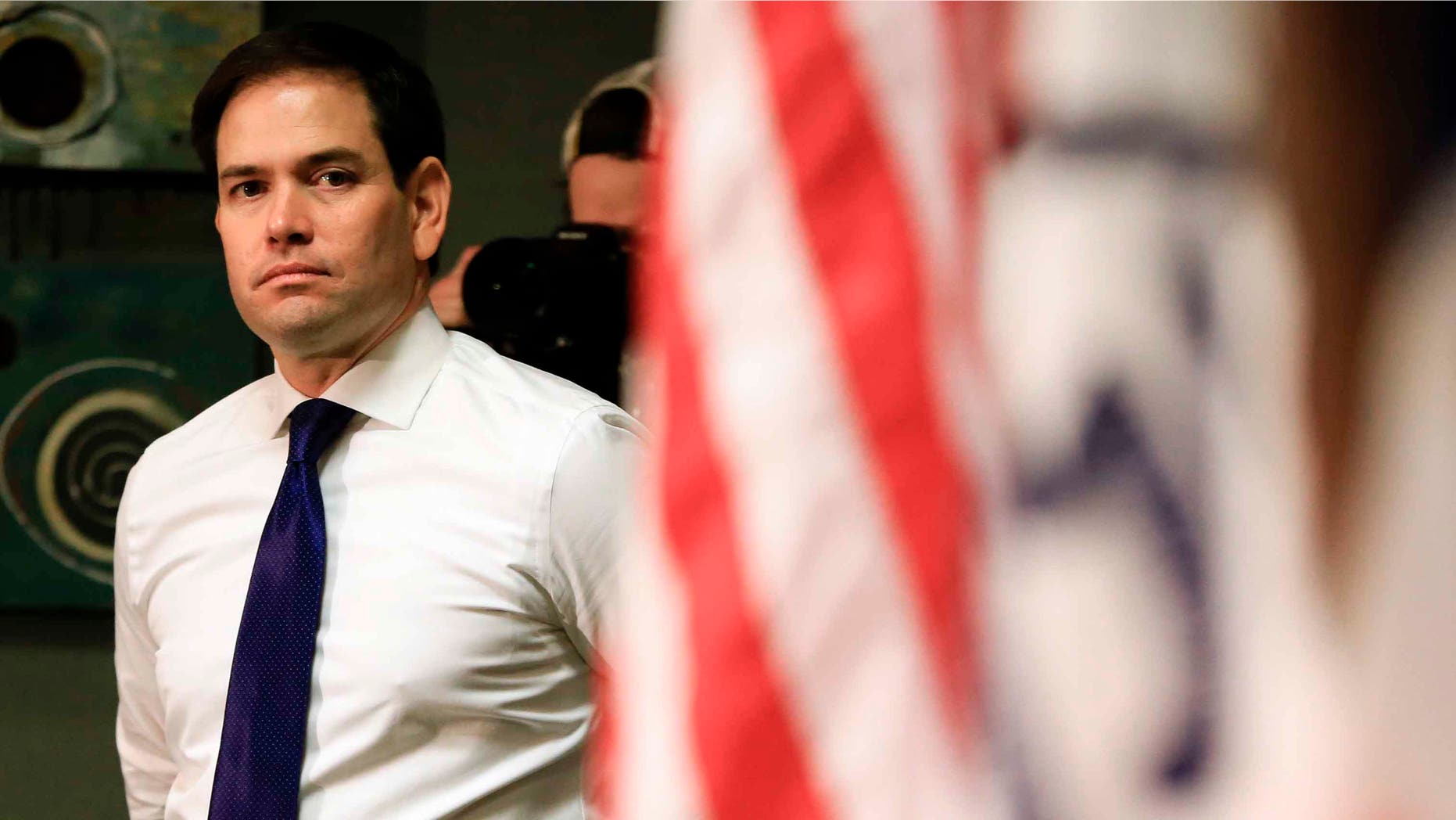 Sen. Marco Rubio waits at the side of the stage in Council Bluffs, Iowa, Sat. Jan. 16, 2016.