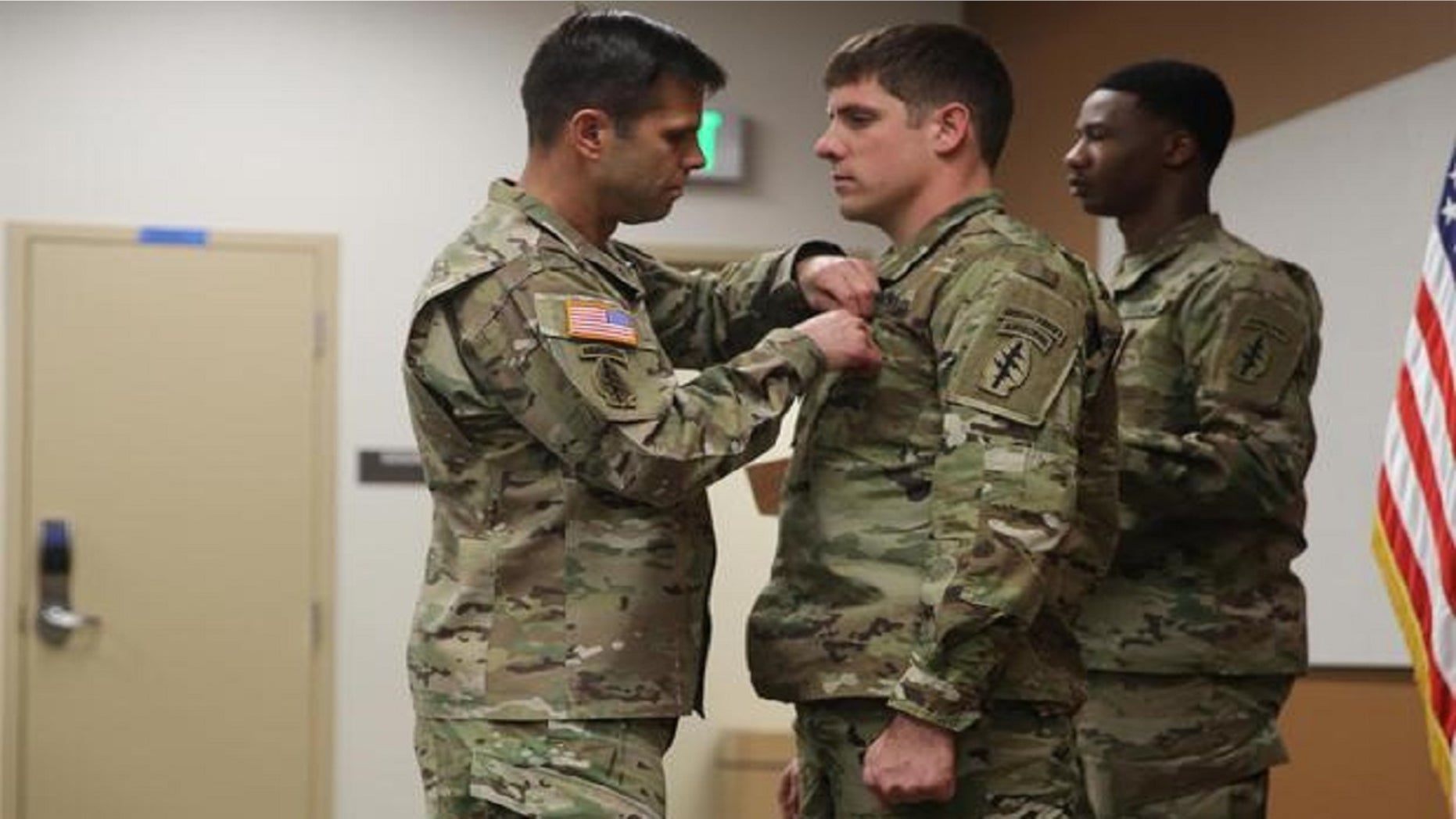 Brig. Gen. Richard Angle pins the Soldier’s Medal on Staff Sgt. Adams on Monday.