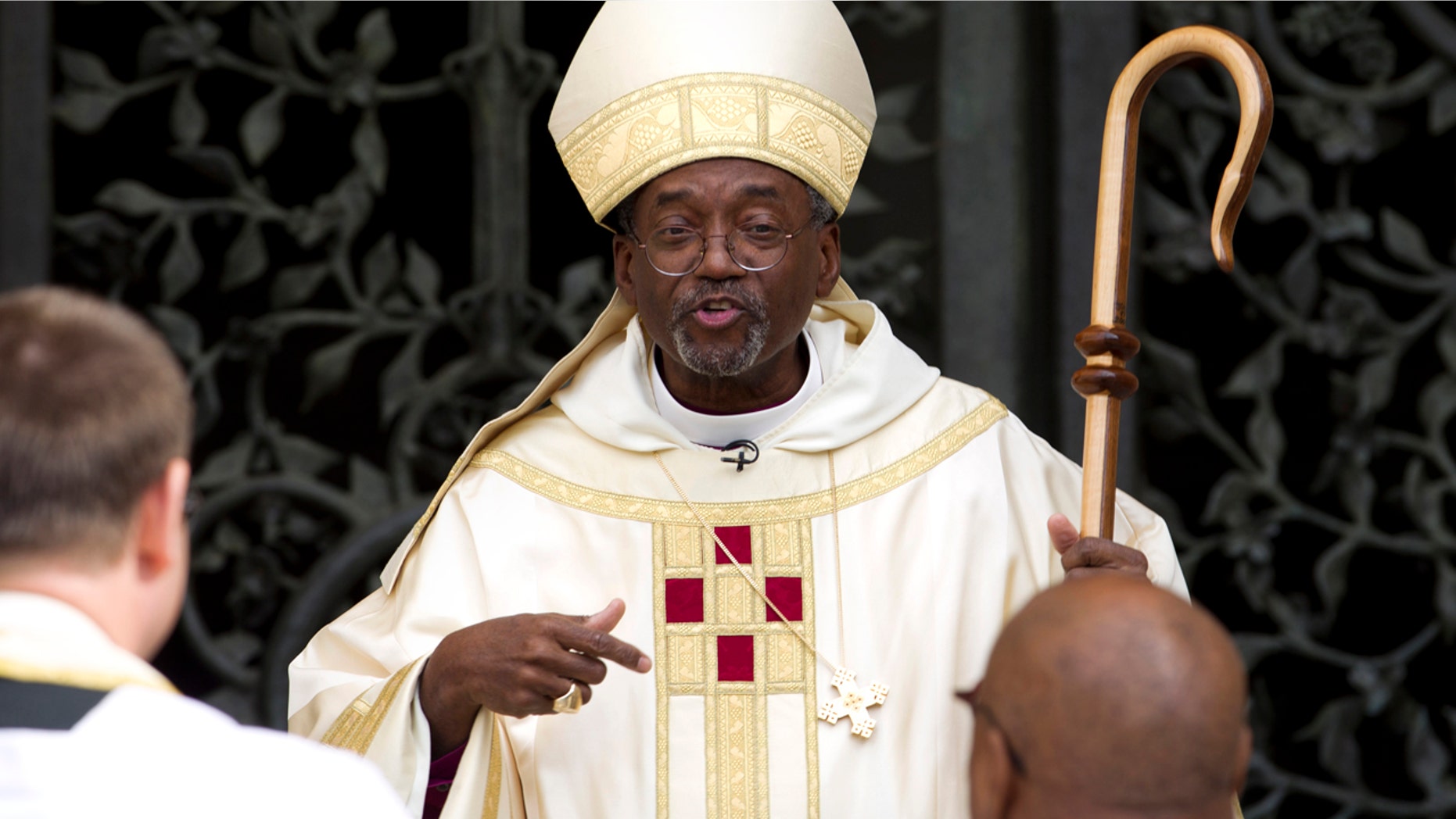 FILE - In this Sunday, Nov. 1, 2015 file photo, Episcopal Church Presiding Bishop-elect Michael Curry speaks to churchgoers as he arrives at the Washington National Cathedral in Washington. (AP Photo/Jose Luis Magana)