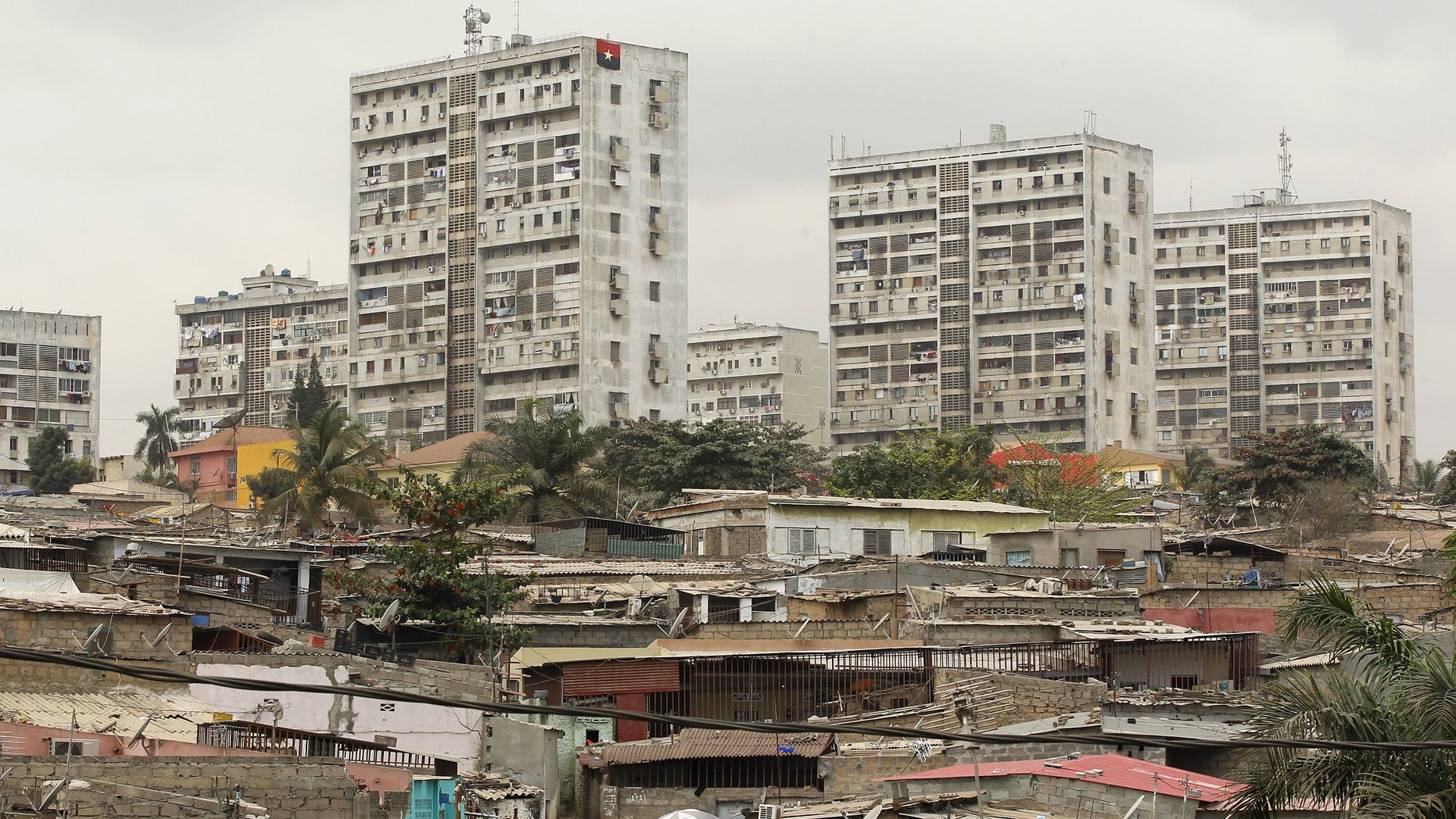 High-rise buildings are seen behind informal settlements in the capital of Luanda, in this August 30, 2012 file photo. REUTERS/Siphiwe Sibeko/Files - RTX2A2MP
