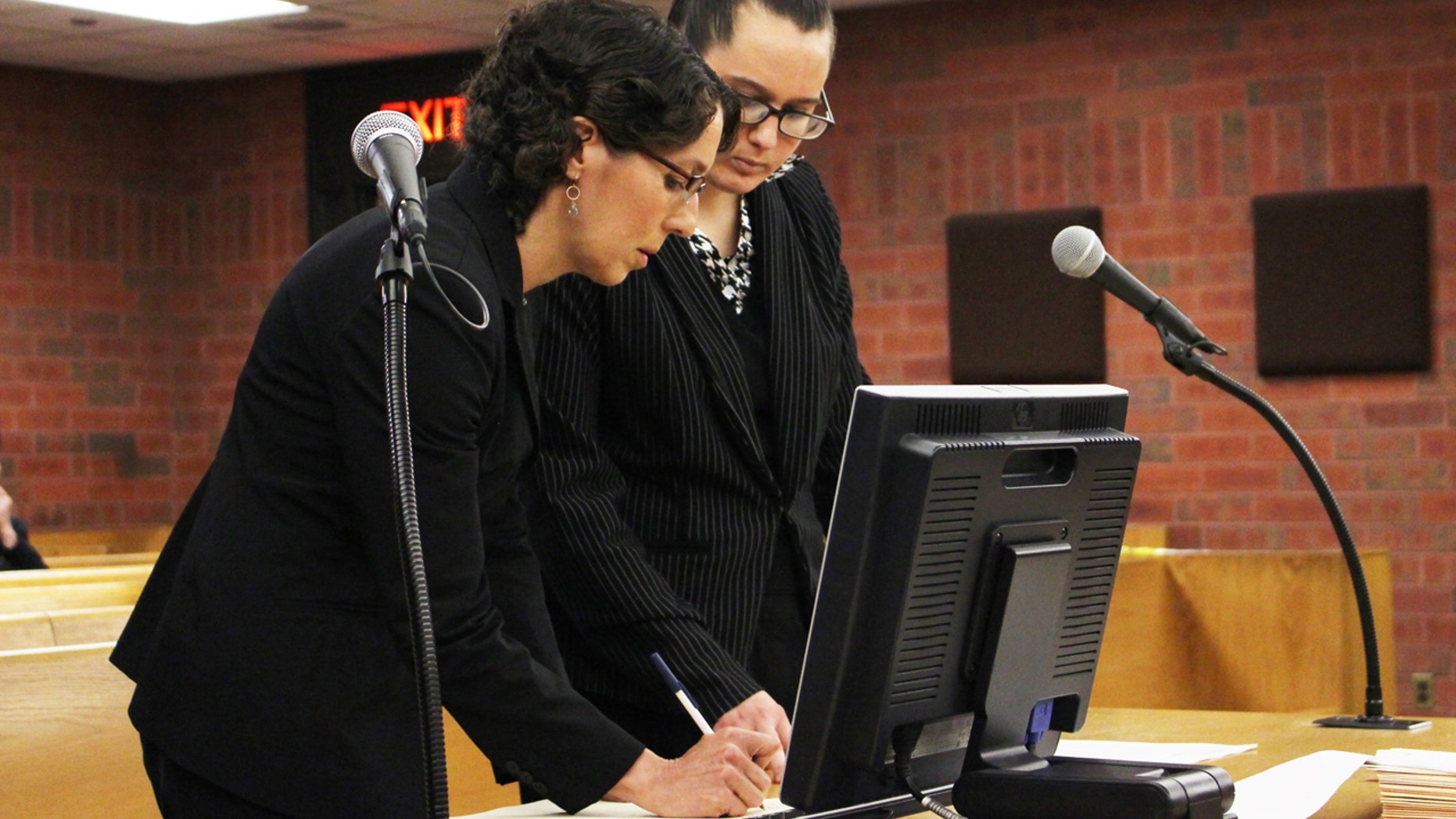 University of Connecticut law professor Jessica Rubin, left, and law student Taylor Hansen prepare to present arguments as animal advocates in a dog fighting case on May 30, 2017, in Superior Court in Hartford, Conn.