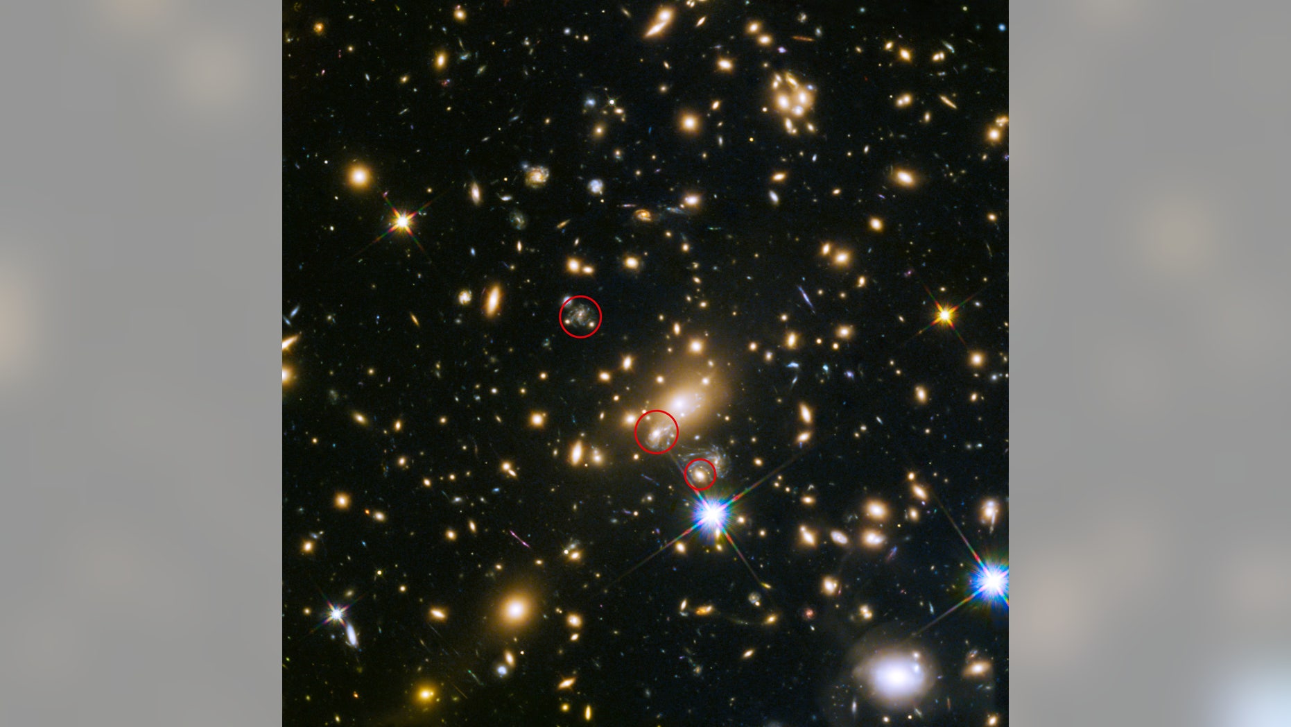 This image shows the appearances of the Refsdal supernova. The uppermost circle shows the position of the supernova as it could have been seen in 1998. The lowermost circle shows the galaxy which lensed the supernova four time â a discovery made in late 2014. The middle circle shows the latest position of the reappearing supernova in 2015.