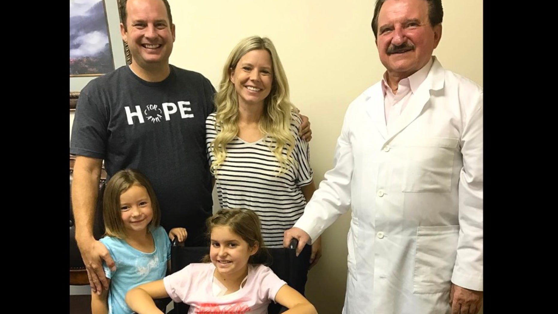 Anna, seated, is pictured with her parents and Dr. Burzynski.