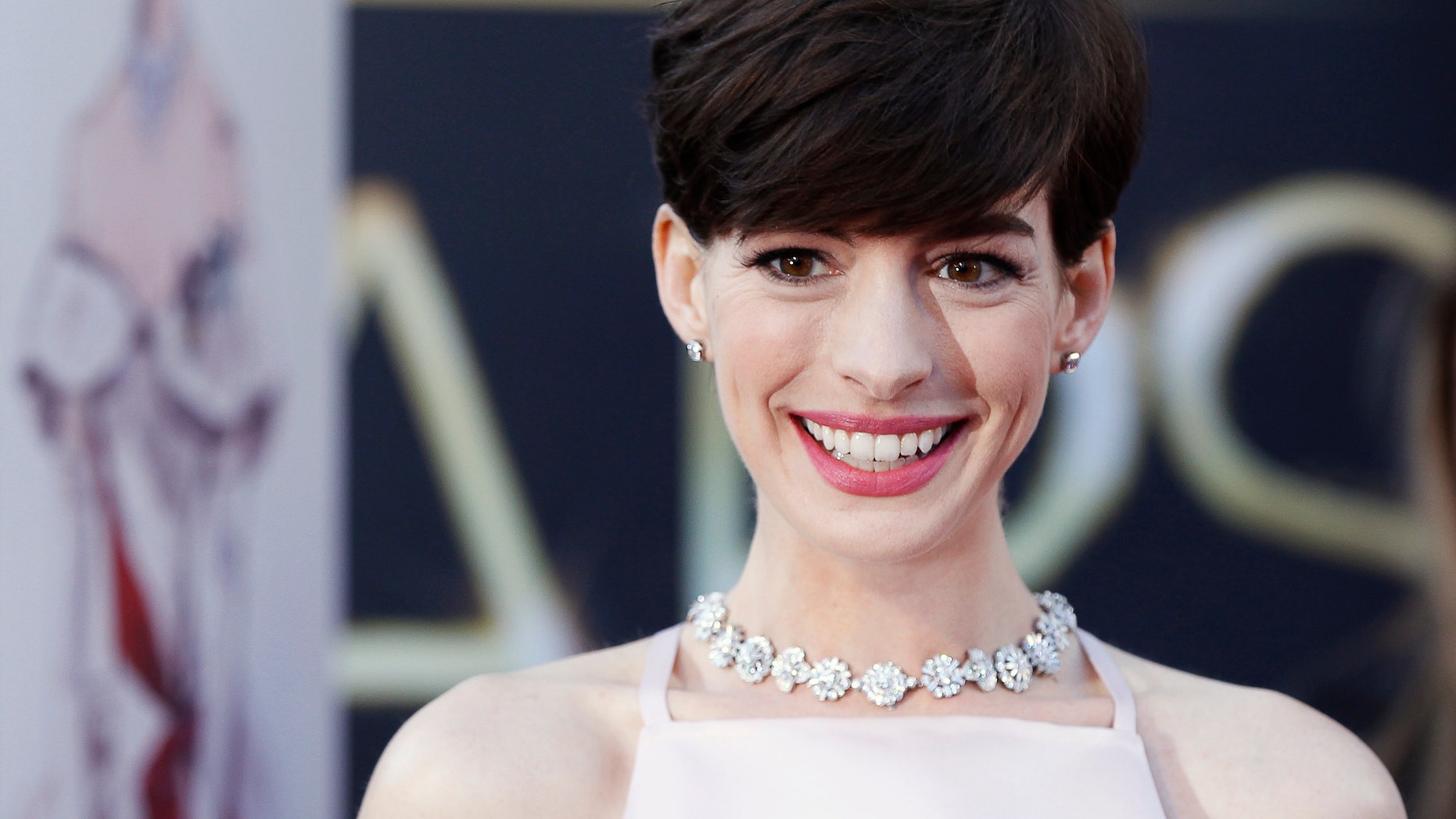 February 24, 2013. Anne Hathaway, best supporting actress nominee for her role in "Les Miserables" arrives at the 85th Academy Awards in Hollywood, California.