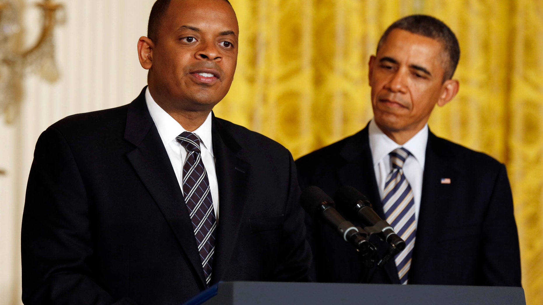U.S. President Barack Obama listens to Charlotte, N.C., Mayor Anthony Foxx after naming him to replace Ray LaHood as U.S. Transportation Secretary in the East Room of the White House in Washington.