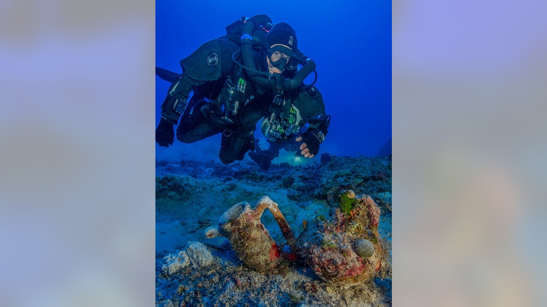An archaeologist swims over artifacts at the site of the Antikythera shipwreck. In 2015, researchers pulled 50 new objects from the depths as part of the first scientific excavation of the wreck site.