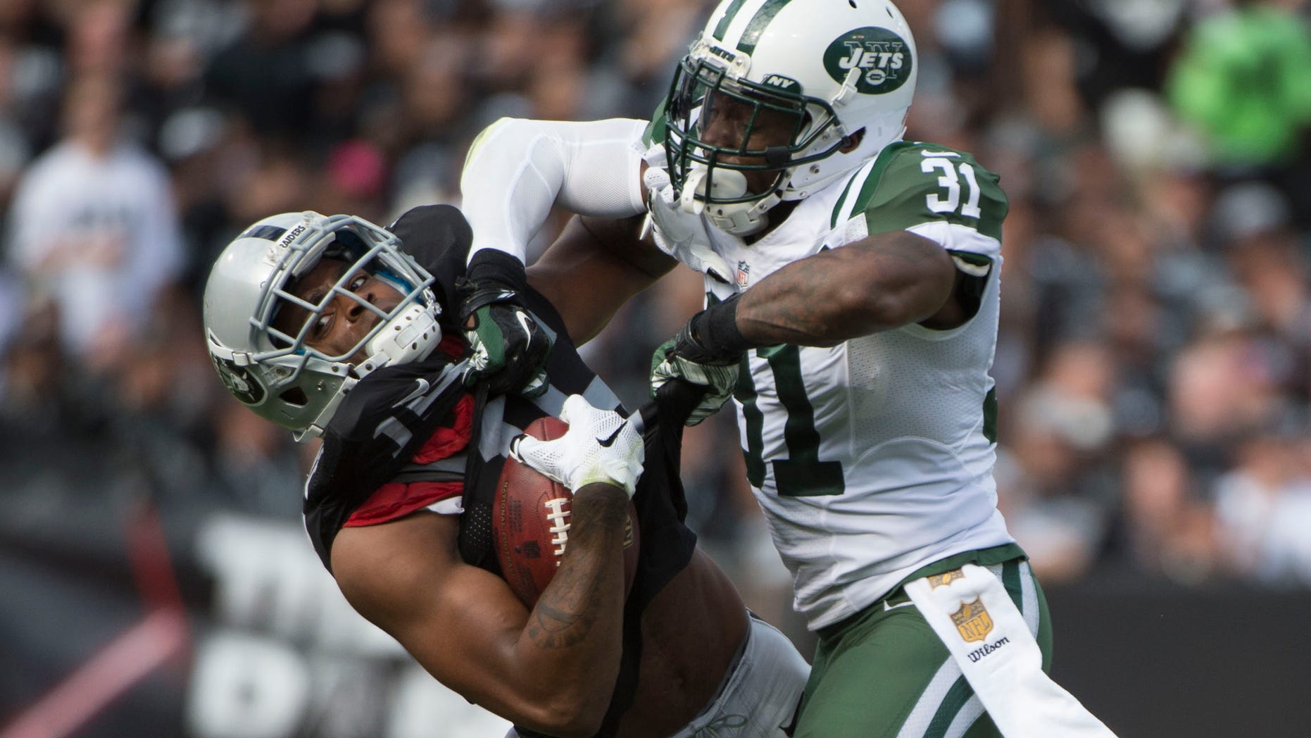 November 1, 2015; Oakland, CA, USA; New York Jets cornerback Antonio Cromartie (31) tackles Oakland Raiders wide receiver Michael Crabtree (15) during the second quarter at O.co Coliseum.