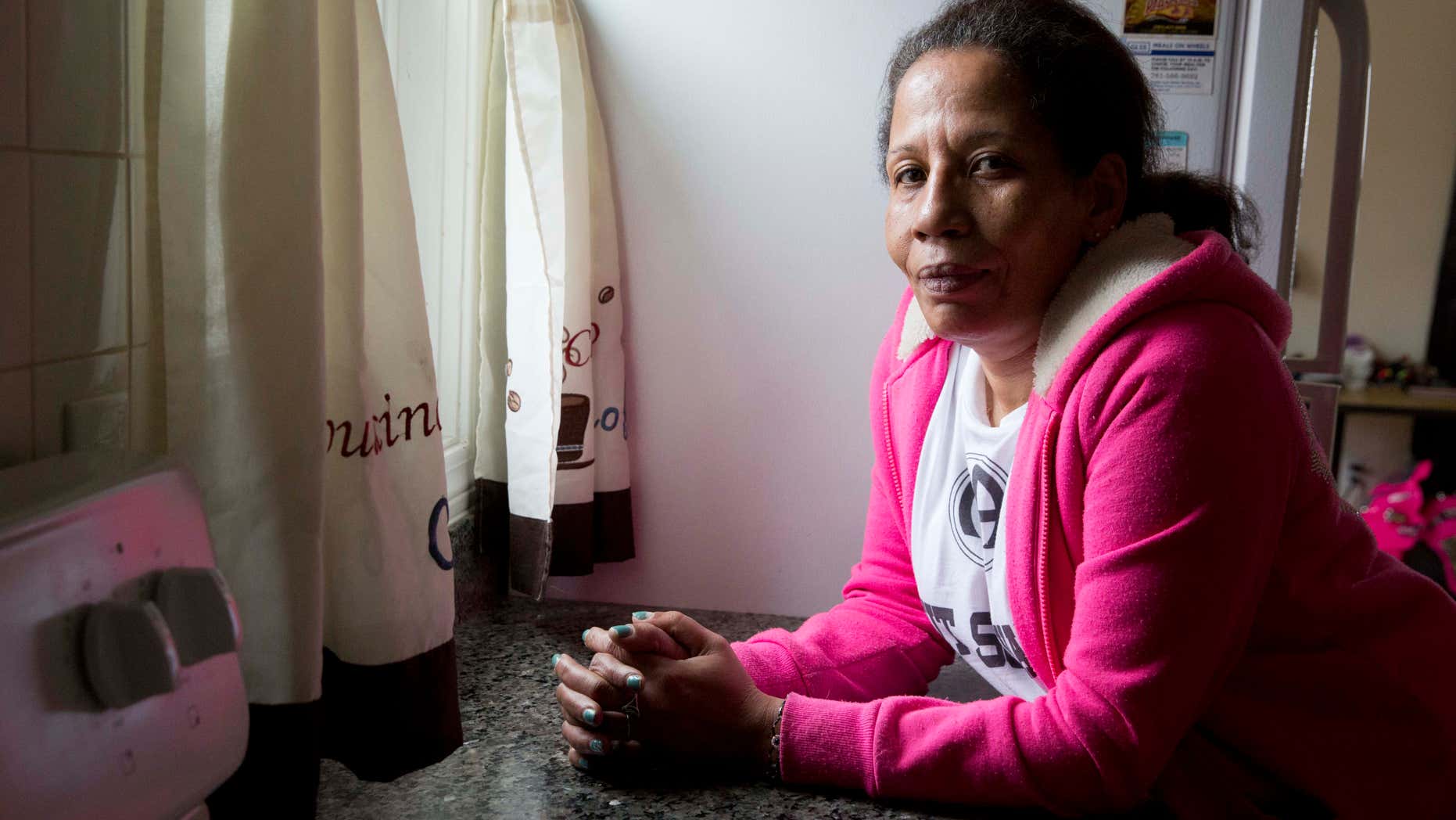 In this photo taken March 24, 2016, Sharon Johnson poses in her apartment in Lynn, Mass. Johnson calls herself an addict, although shes been sober for three years now. She started by smoking pot and eventually moved to crack cocaine. Her daughter has tried heroin and I believe Im going to pull her out of the gutter someday, she laments. (AP Photo/Michael Dwyer)