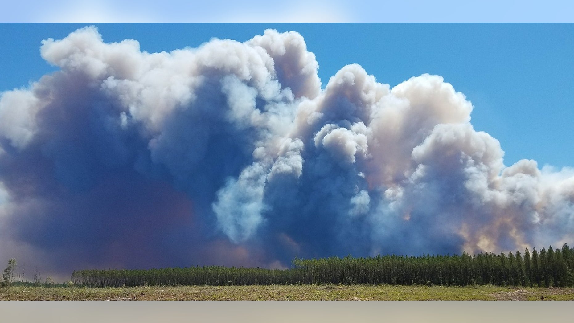 Smoke is seen rising from a wildfire around Fargo, Georgia on Saturday. Residents in St. George, Canaday Loop and Moniac have been ordered to evacuate.