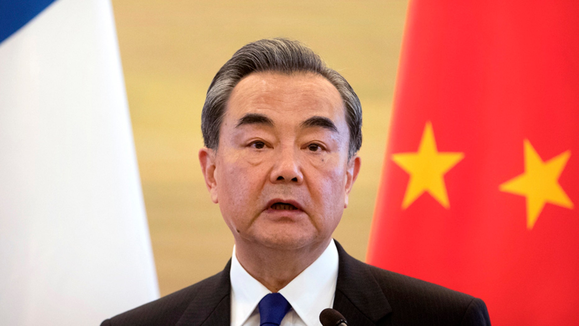 Chinese Foreign Minister Wang Yi speaks during a joint press conference with his French counterpart Jean-Marc Ayrault at the Ministry of Foreign Affairs in Beijing, Friday, April 14, 2017. (AP Photo/Mark Schiefelbein)