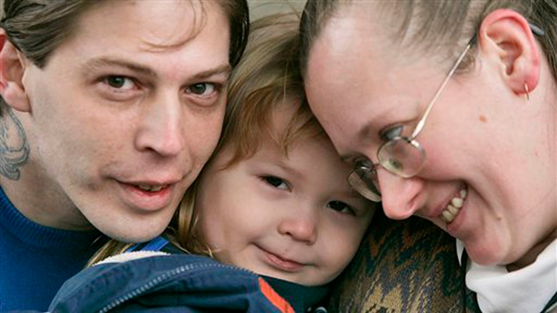 FILE - This Tuesday, Dec. 16, 2008 file photo, shows Isidore Heath Campbell, left, his wife, Deborah, and son Adolf Hitler Campbell, 3, in Easton, Pa. On Monday, May 8, 2017, Isidore Heath Campbell officially became Isidore Heath Hitler. He first gained national attention when a supermarket refused to decorate a birthday cake for his son, Adolf Hitler. (AP Photo/Rich Schultz, File)