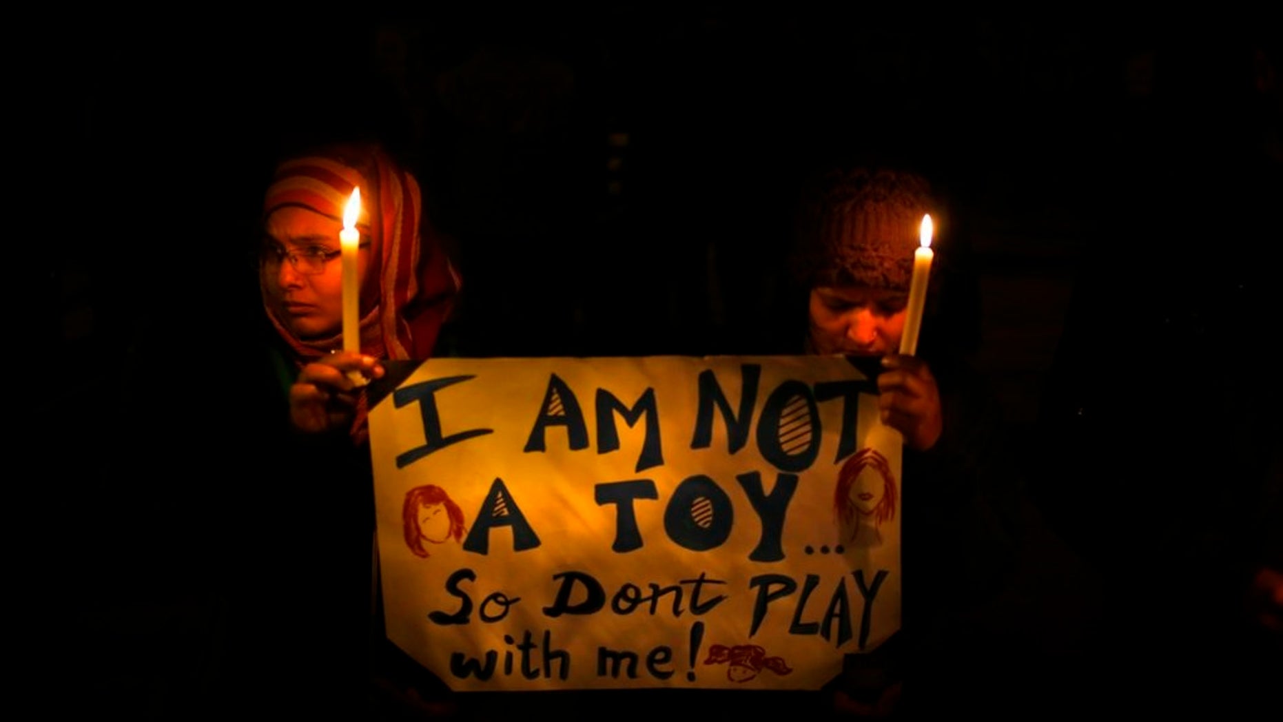 People in India hold a candlelight vigil in New Delhi to mourn the death of a gang rape victim in December 2012.