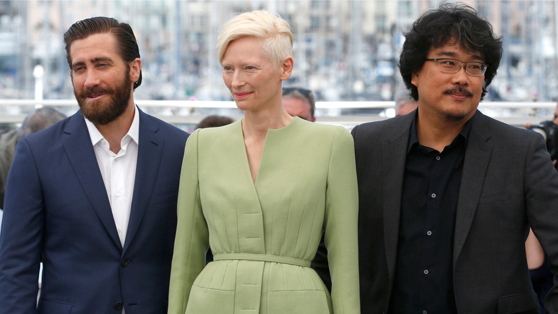 Actors Jake Gyllenhaal, from left, Tilda Swinton and director Bong Joon-Ho pose for photographers during the photo call for the film Okja at the 70th international film festival, Cannes, southern France, Friday, May 19, 2017. (AP Photo/Alastair Grant)