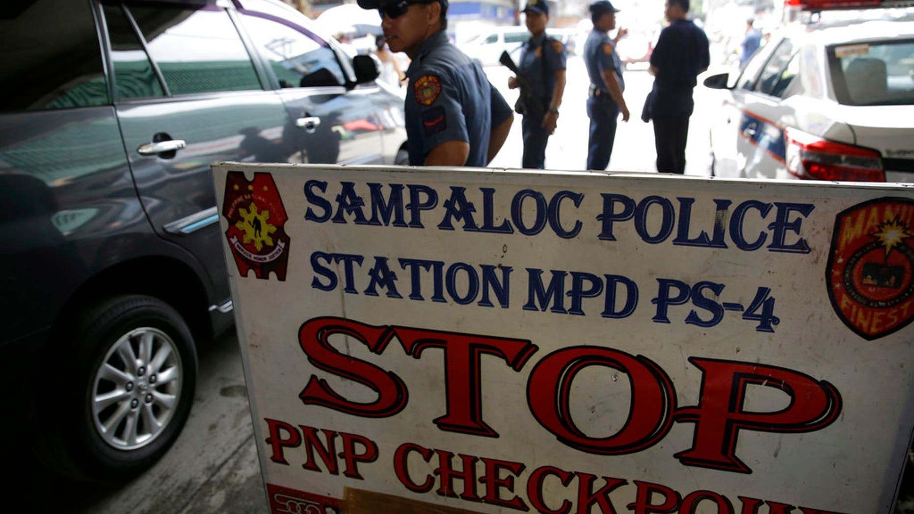 Policemen watches vehicles at a checkpoint in Manila, Philippines, Wednesday, May 24, 2017 as the Philippine National Police is placed under full alert status following the declaration of martial law in Mindanao southern Philippines. (Associated Press)