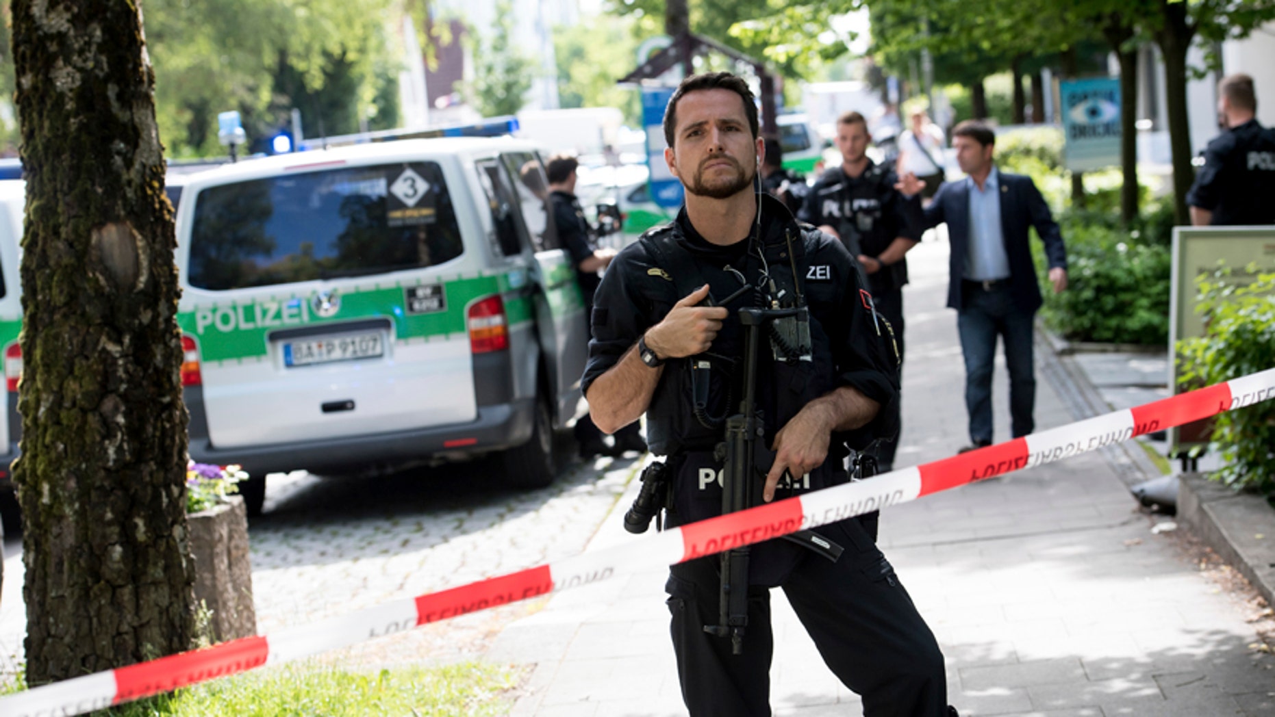 Police block a street near a subway station in Munich, Germany, Tuesday, June 13, 2017. Several people were injured, including a police officer, in a shooting early Tuesday at a Munich subway station, police said. Munich police said in a tweet that the policewoman's injuries were serious. The suspect was also injured and is in custody. The shooting occurred during a morning police check at the Unterfoehring subway station, Munich police spokesman Michael Riehlein said. (Sven Hoppe/dpa via AP)