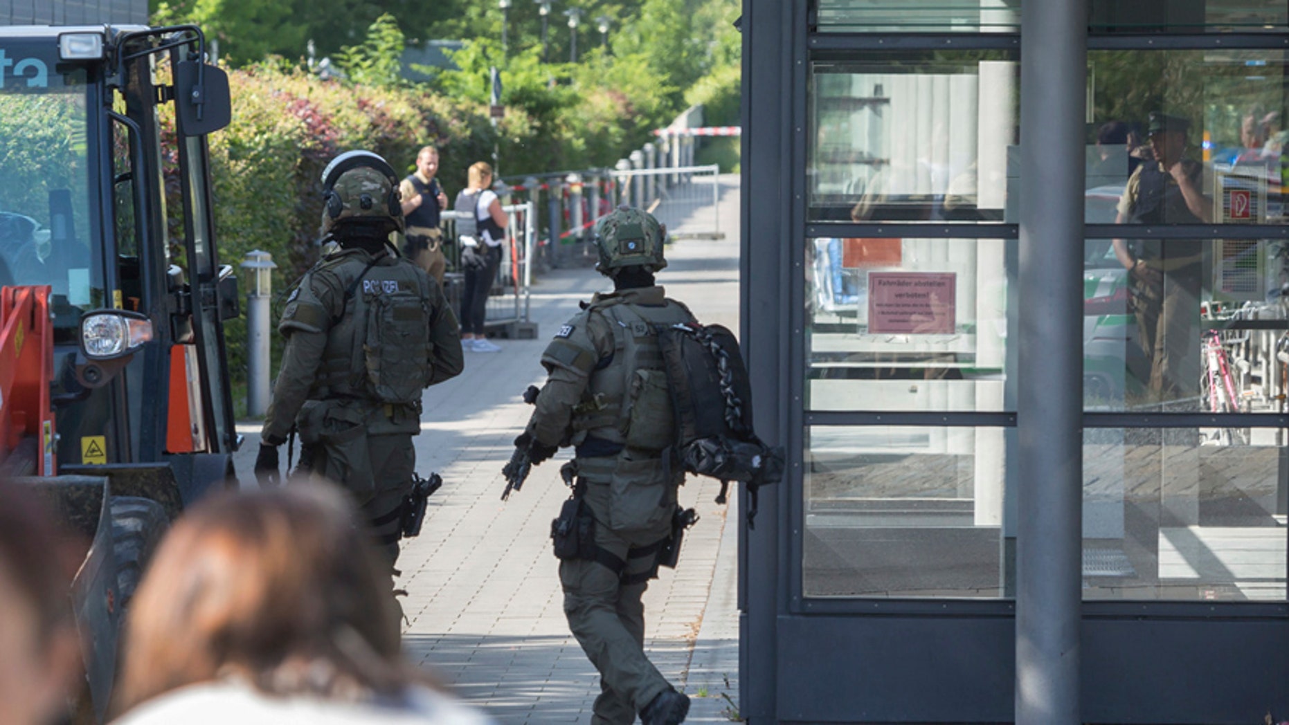 Special police guard outside a subway station in Munich, Germany, Tuesday, June 13, 2017. Several people were injured, including a police officer, in a shooting early Tuesday at a Munich subway station, police said. Munich police said in a tweet that the policewoman's injuries were serious. The suspect was also injured and is in custody. The shooting occurred during a morning police check at the Unterfoehring subway station, Munich police spokesman Michael Riehlein said. (Andreas Prott/dpa via AP)