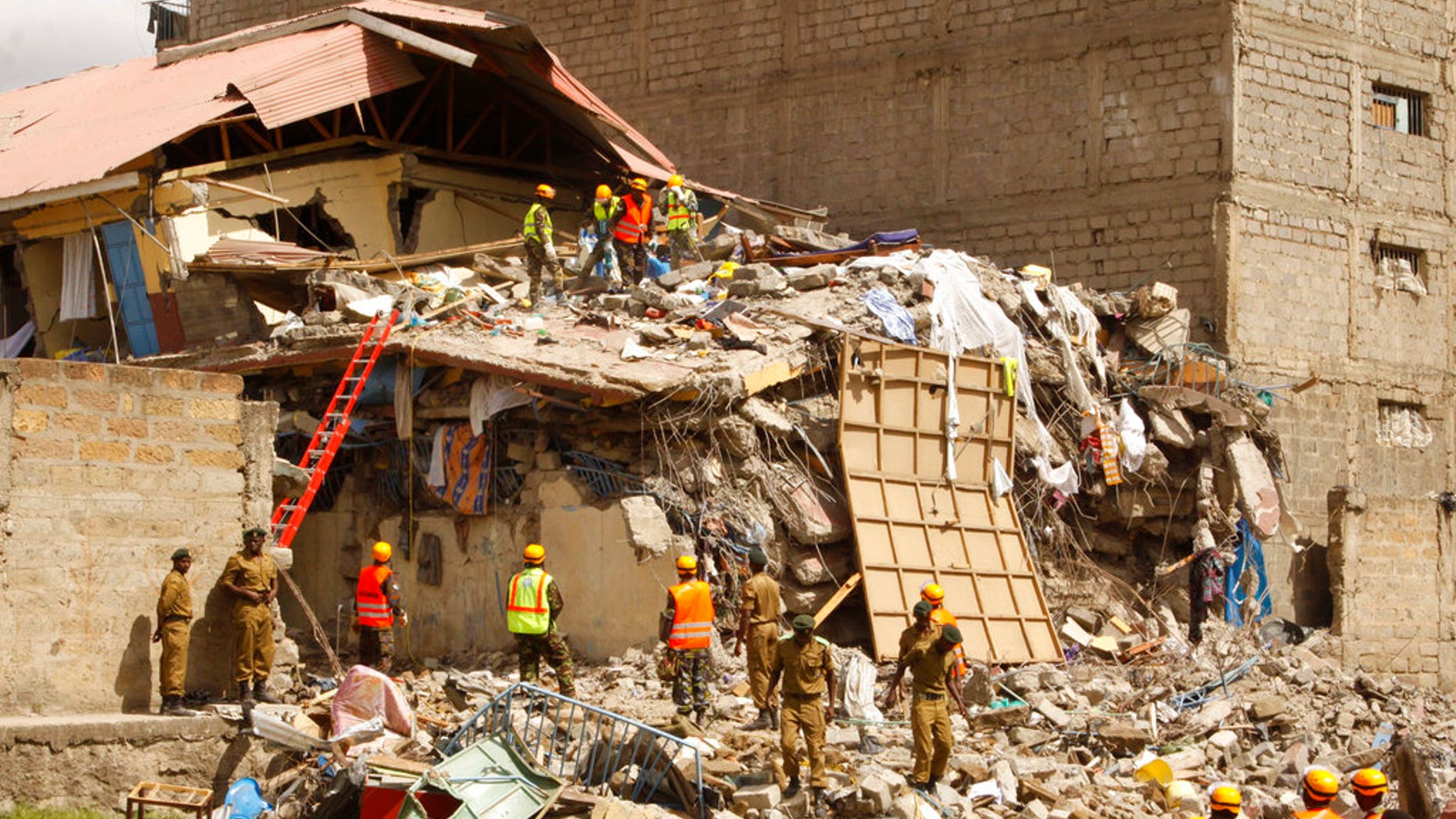 Rescuers work at the site of a building collapse in Nairobi, Kenya Tuesday, June 13, 2017. Nairobi Police Chief Japheth Koome said Tuesday that at least 10 people had been reported missing after the collapse Monday night. (AP Photo/Khalil Senosi)